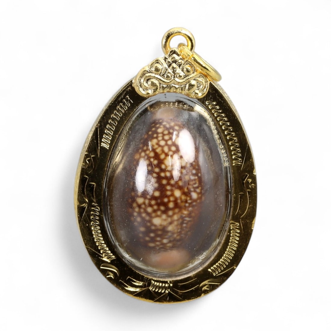 Vintage Thai Cowrie Shell Amulet Prosperity Talisman in Gilt Oval Case, c. Mid-20th Century, 8g: This vintage Thai amulet features a naturally polished cowrie shell, a revered symbol of wealth, fertility, and oceanic energy in Southeast Asian and South Asian traditions. Housed in a protective ova