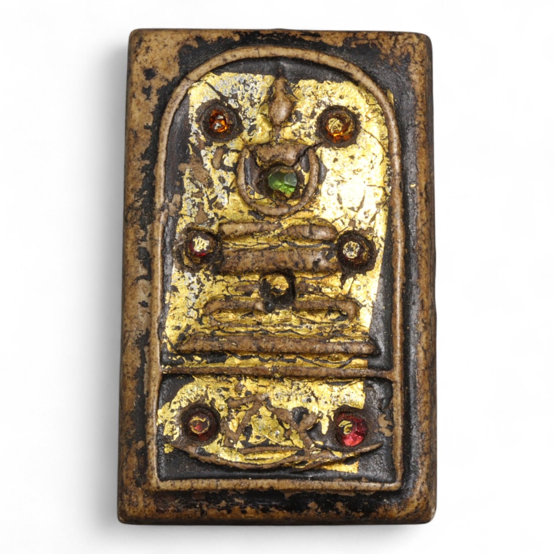 Antique Thai Jeweled Gilded Buddha Clay Amulet, c. 19th-20th Century - 24g: This striking antique Thai amulet, crafted from clay and adorned with gold leaf and inset glass jewels, exemplifies devotional artistry from the late Rattanakosin period (19th-20th century). At the ce