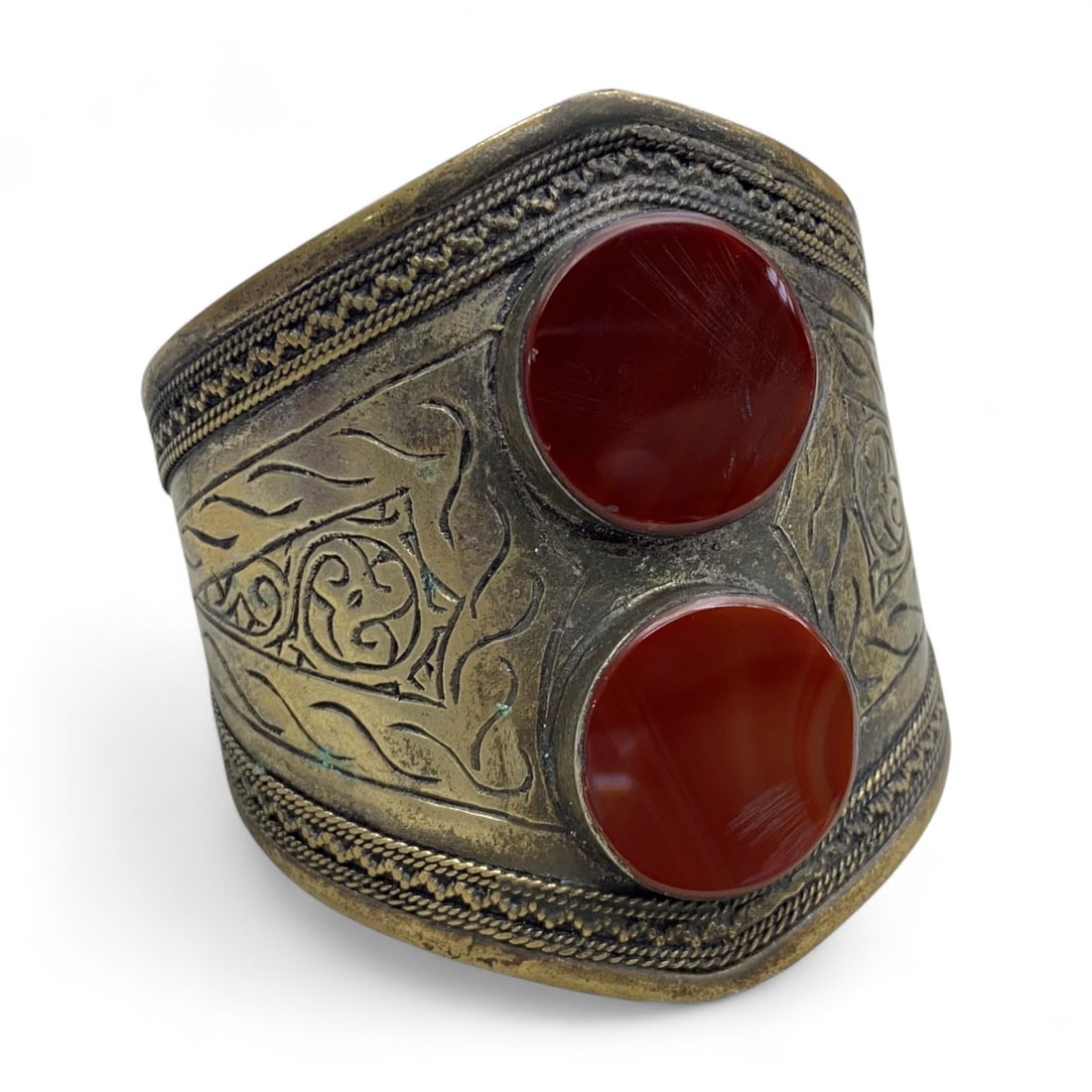 Vintage Himalayan Tribal Carnelian Brass Bracelet, 20th Century, 52g: This vintage Himalayan bracelet radiates warmth and strength through its bold use of carnelian, a stone revered across the region for its protective and energizing qualities. The design features two r