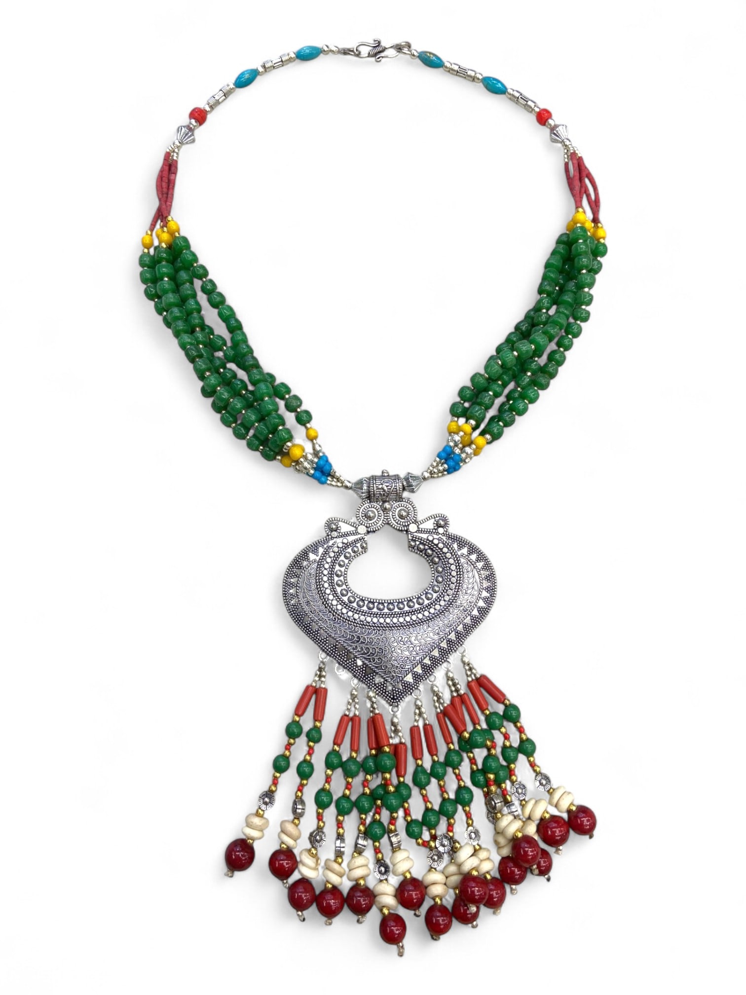 Vintage Himalayan Tribal Coral Green Bead Silver Pendant Necklace, 20th Century, 135g: This vintage Himalayan necklace features a bold heart-shaped silver pendant, intricately worked with repousse patterns and suspended with cascading strands of coral, green, ivory-toned, and red beads.