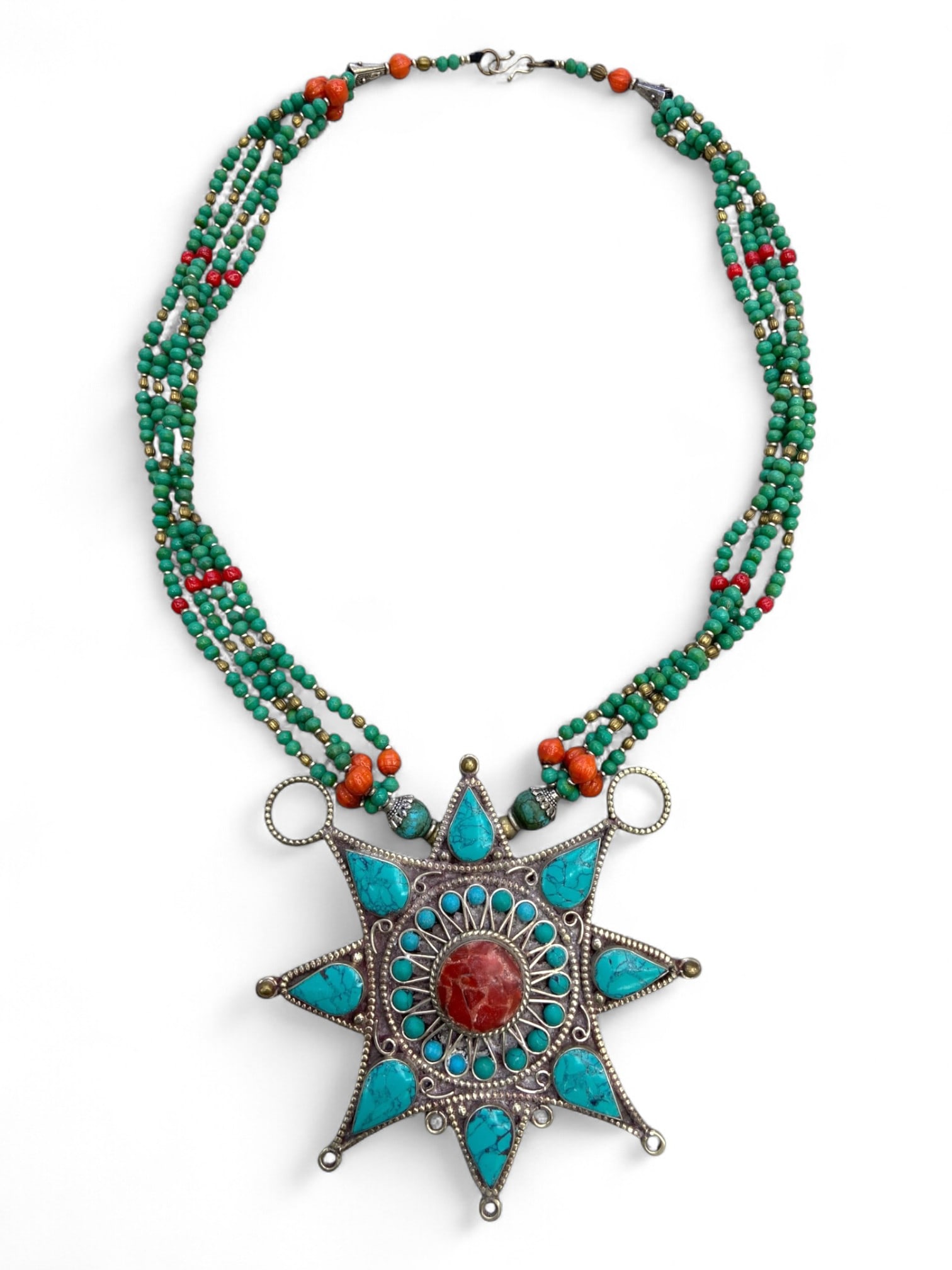 Vintage Himalayan Tribal Coral Turquoise Silver Star Pendant Necklace, 20th Century, 140g: This vintage Himalayan necklace is defined by its dramatic star-shaped silver pendant, radiating with turquoise and coral inlays. At the center rests a bold round coral cabochon, surrounded by concent