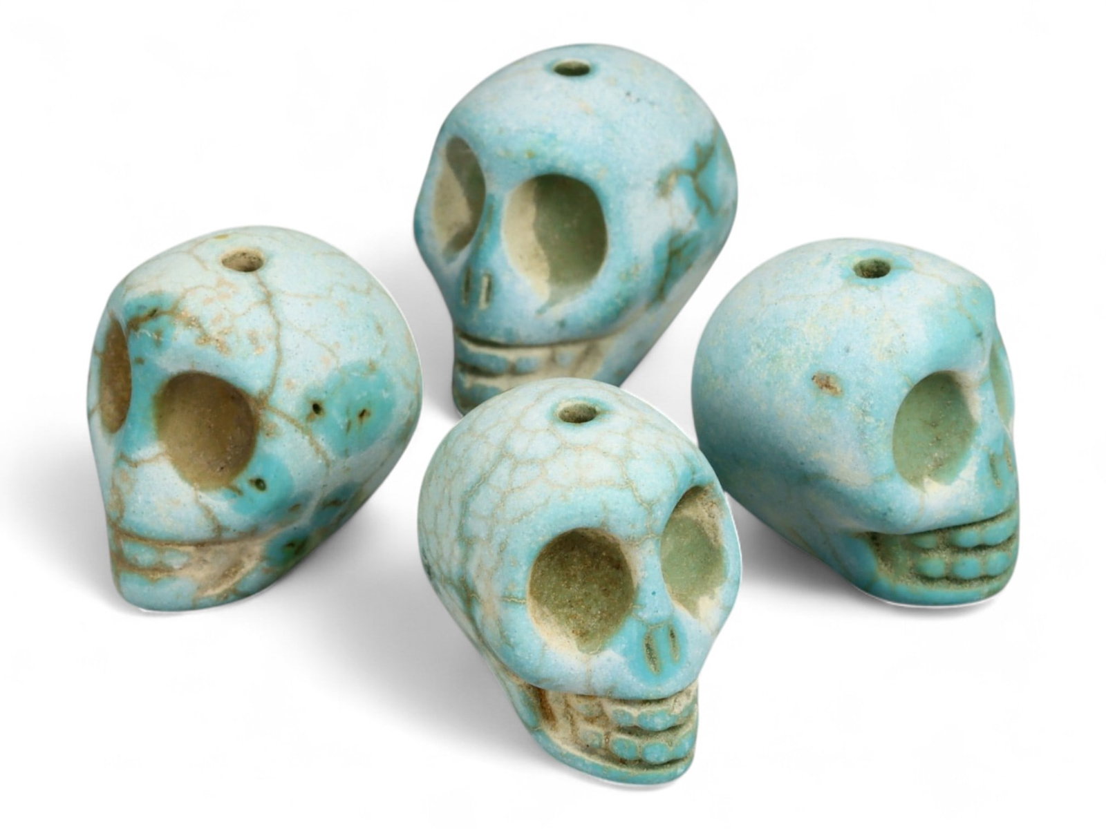 Vintage Tibetan Turquoise Skull Beads, Set of Four, c. Mid-20th Century, 2cm: This striking set of four turquoise-carved skull beads, each measuring approximately 2 cm, originates from Tibet and dates to the mid-20th century. Finely shaped and perforated for stringing, each bea