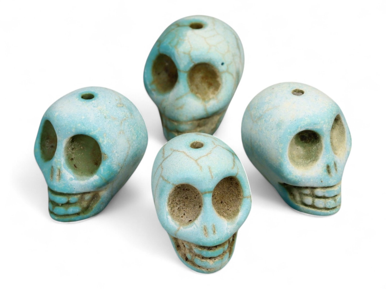 Vintage Tibetan Turquoise Skull Beads, Set of Four, c. Mid-20th Century, 2cm: This striking set of four turquoise-carved skull beads, each measuring approximately 2 cm, originates from Tibet and dates to the mid-20th century. Finely shaped and perforated for stringing, each bea