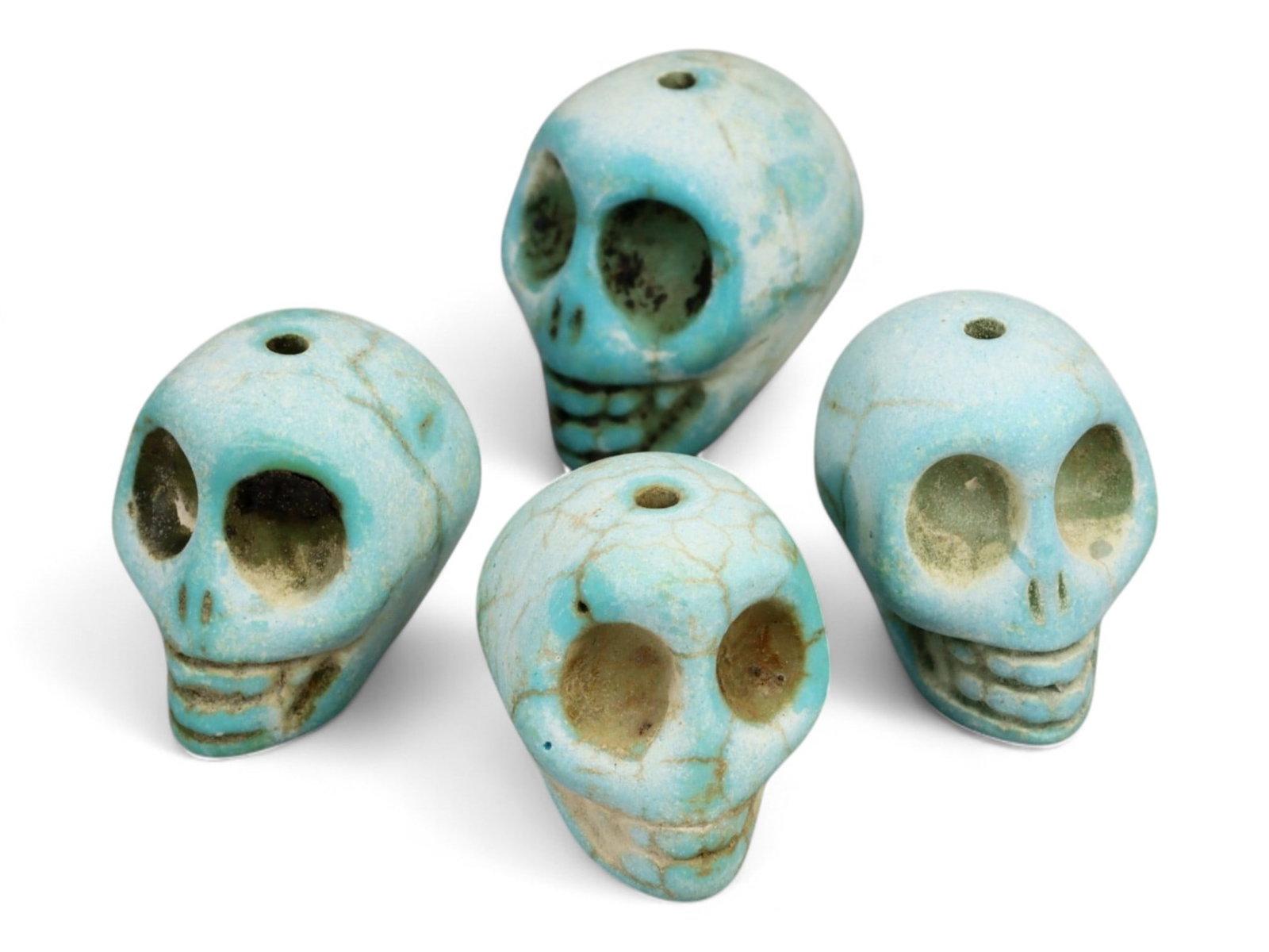 Vintage Tibetan Turquoise Skull Beads, Set of Four, c. Mid-20th Century, 2cm: This striking set of four turquoise-carved skull beads, each measuring approximately 2 cm, originates from Tibet and dates to the mid-20th century. Finely shaped and perforated for stringing, each bea