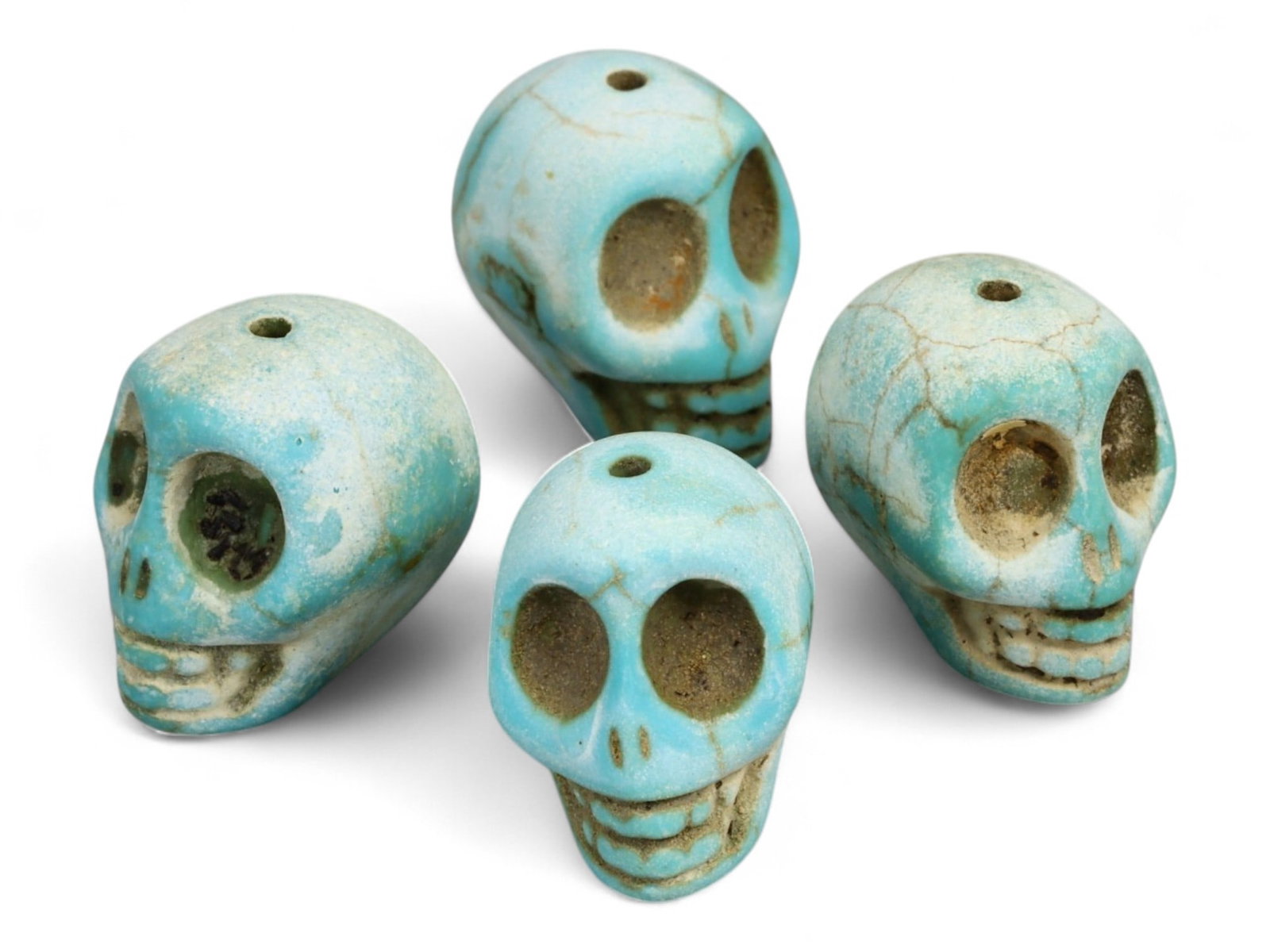 Vintage Tibetan Turquoise Skull Beads, Set of Four, c. Mid-20th Century, 2cm: This striking set of four turquoise-carved skull beads, each measuring approximately 2 cm, originates from Tibet and dates to the mid-20th century. Finely shaped and perforated for stringing, each bea