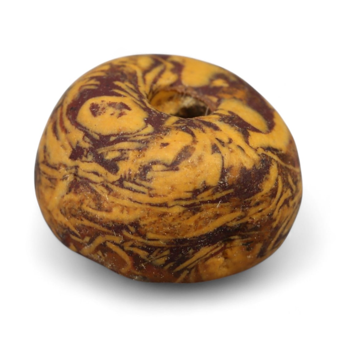 Ancient Indus Valley Fossilized Stromatolite Bead, c. 3rd-2nd Millennium BCE, 0.7cm: This remarkable bead is carved from fossilized stromatolite, a stone composed of layered mineral deposits created by some of Earth's earliest microbial life. Stromatolite beads were especially prized 