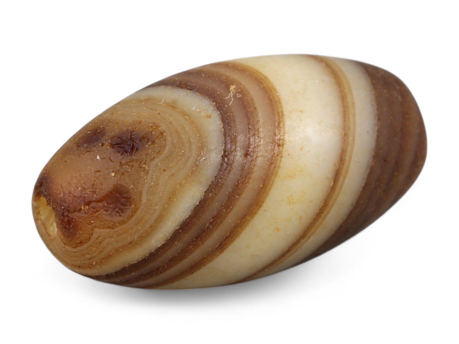 Ancient Indus Valley Banded Agate Lentoid Bead, c. 3rd Millennium BCE, 1.5cm: This elegant bead, carved from banded agate, dates to the Indus Valley Civilization (c. 3300-1300 BCE), one of the world's earliest urban cultures. The Indus people were renowned for their sophisticat