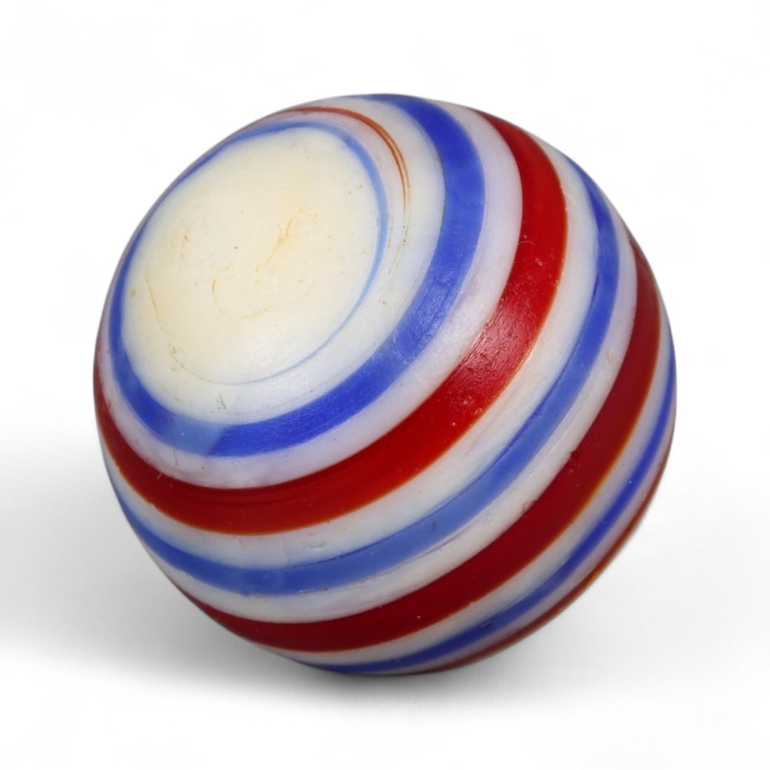 Vintage Swirled Pattern Glass Marble, c. Early-Mid 20th Century, 1.6cm: This charming vintage marble, is crafted from glass with a striking swirl design. Its spiraled pattern, creates a mesmerizing effect that reflects the playful artistry of traditional marble-making. Ea