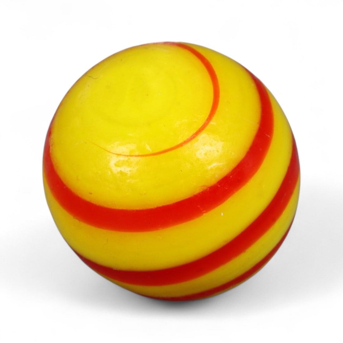 Vintage Swirled Pattern Glass Marble, c. Early-Mid 20th Century, 1.5cm: This charming vintage marble, is crafted from glass with a striking swirl design. Its spiraled pattern, creates a mesmerizing effect that reflects the playful artistry of traditional marble-making. Ea
