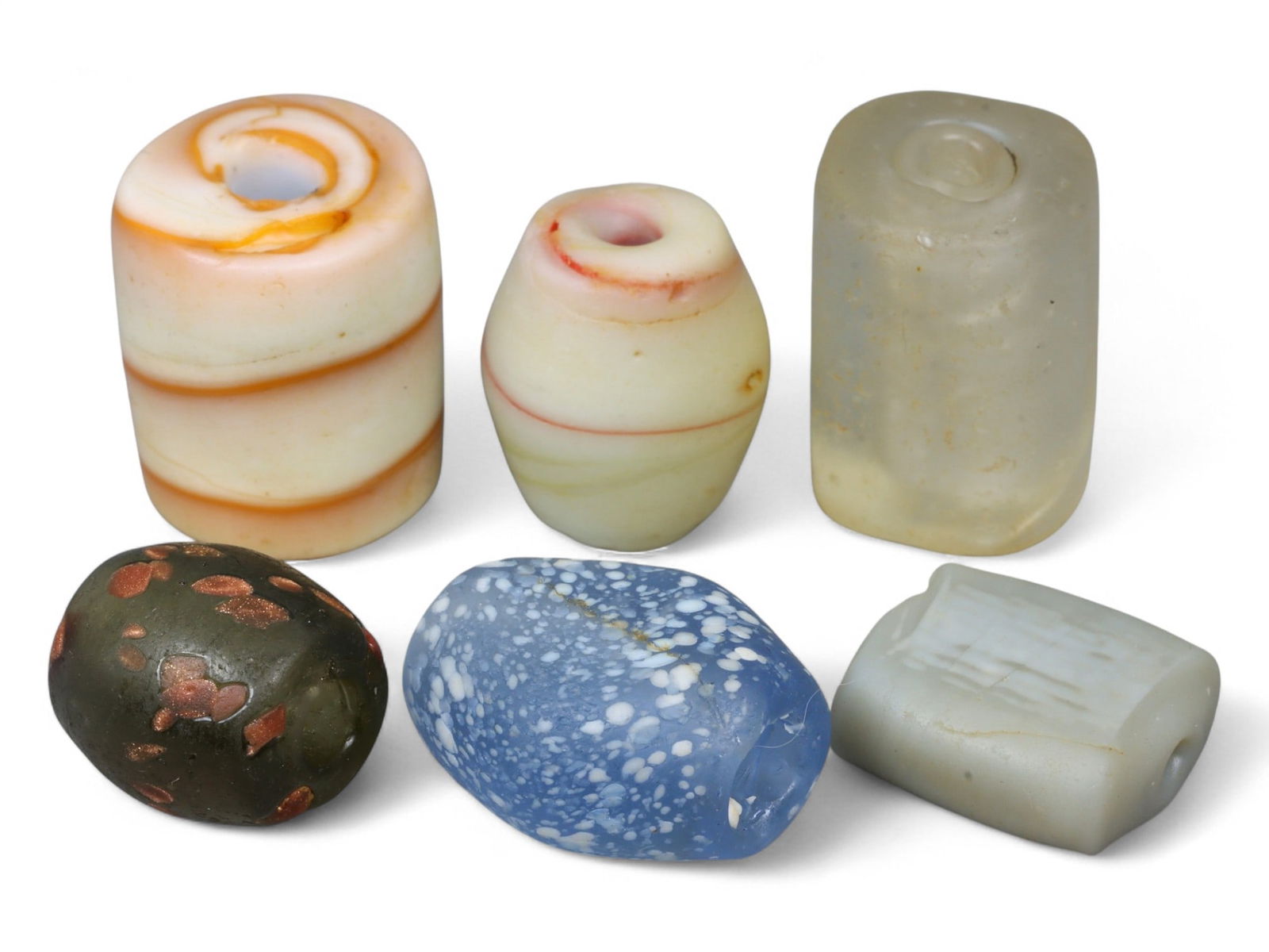 Antique Islamic Glass Bead Collection, Assorted Forms and Colors, c. 18th-19th Century CE, 1.5-2cm: This charming group of six antique glass beads, dating from the 18th-19th century CE, reflects the diversity and artistry of Islamic glassmaking traditions. Measuring between 1.5 and 2 cm, the beads s