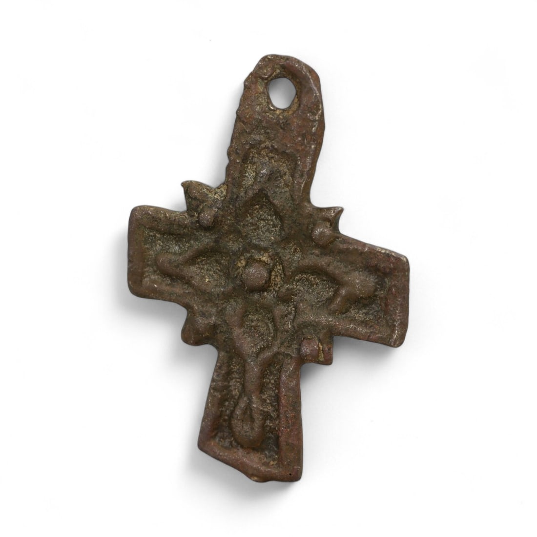 Ancient Byzantine Bronze Cross Pendant with Floral Motif, c. 6th-9th Century CE, 3cm: This small bronze cross pendant, measuring 3 cm, dates to the Byzantine Empire between the 6th-9th century CE. Cast in solid bronze, the pendant features a raised central floral or starburst motif, fr