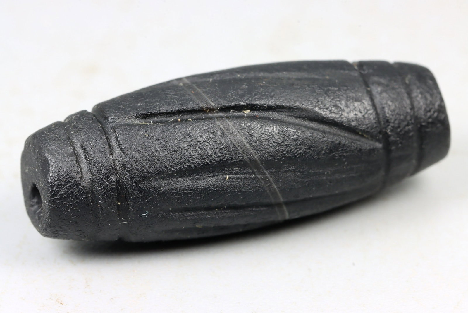 Ancient Roman Grooved Black Stone Barrel Bead, c. 2nd-4th Century CE, 2.6cm (1 of 2)