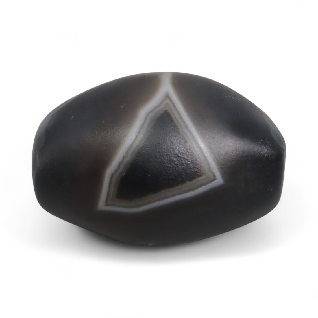 Antique Himalayan Banded Agate Amulet Bead, c. 15th-17th Century, 2.2cm: This bead, carved from banded agate with smoky brown and gray tones, dates to the Himalayan region between the 15th and 17th centuries. Its elongated oval form, shows concentric layering, a characteri