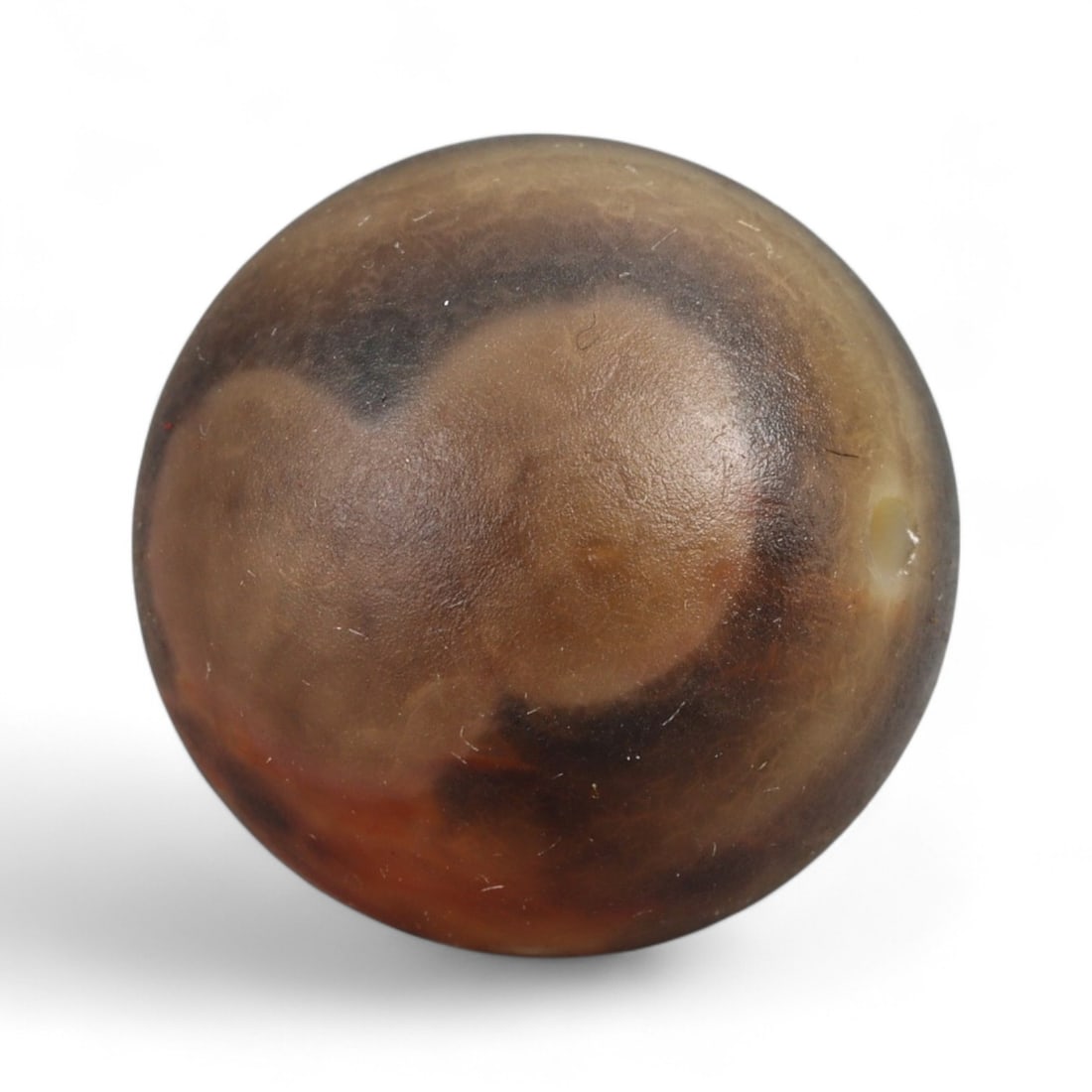 Antique Qajar Agate Eye Motif Bead, c. 19th Century, 1.7cm: This distinctive agate bead, dating to the Qajar Dynasty of 19th century Iran, captures both the artistry and symbolism valued in Persian culture. The naturally occurring concentric eye-like patterns