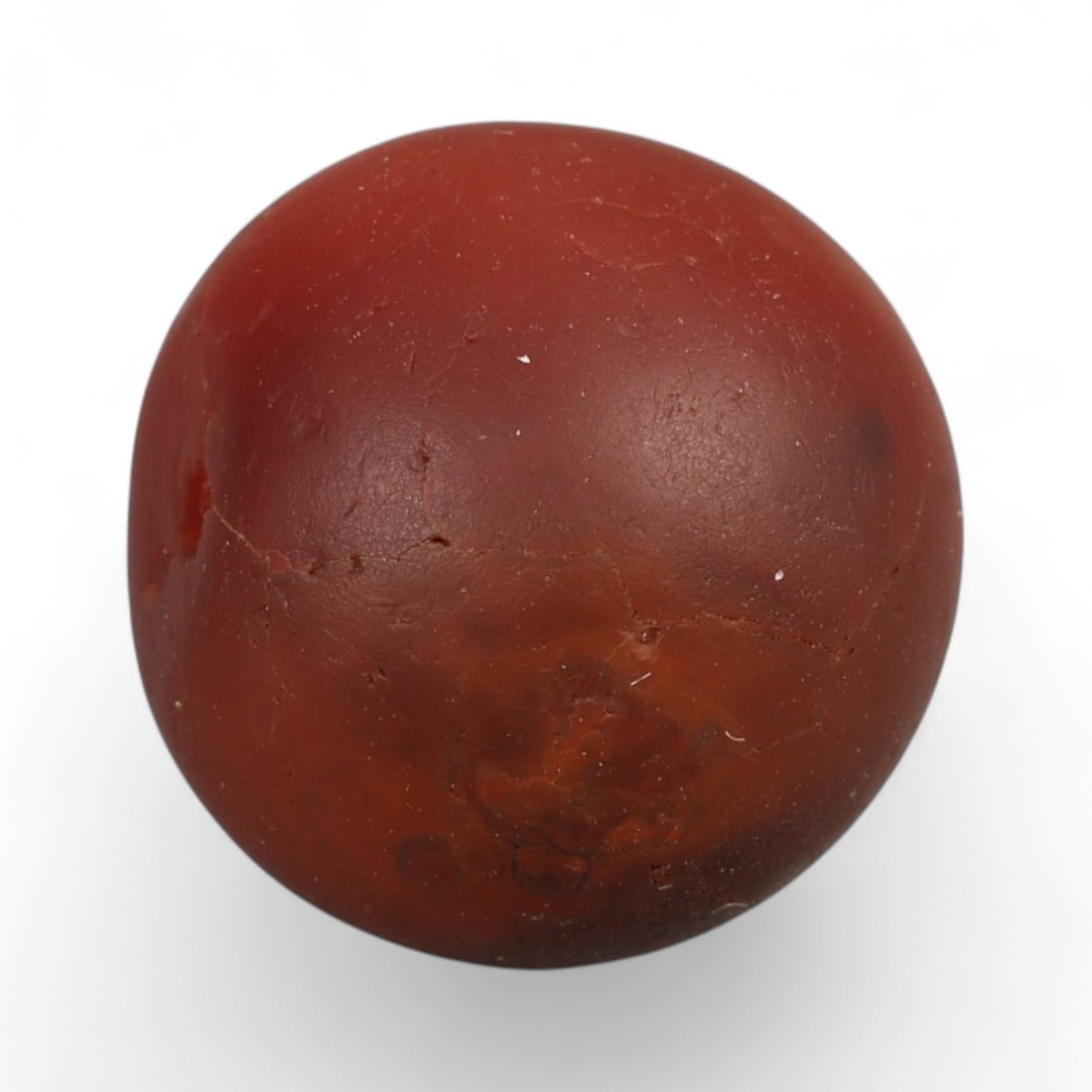 Antique Central Asian Carnelian Bead, c. 18th-19th Century 1.5cm: This warm, russet-toned carnelian bead embodies the enduring lapidary traditions of Central Asia during the 18th-19th centuries. Carefully shaped into a rounded form, its surface shows natural smoothi