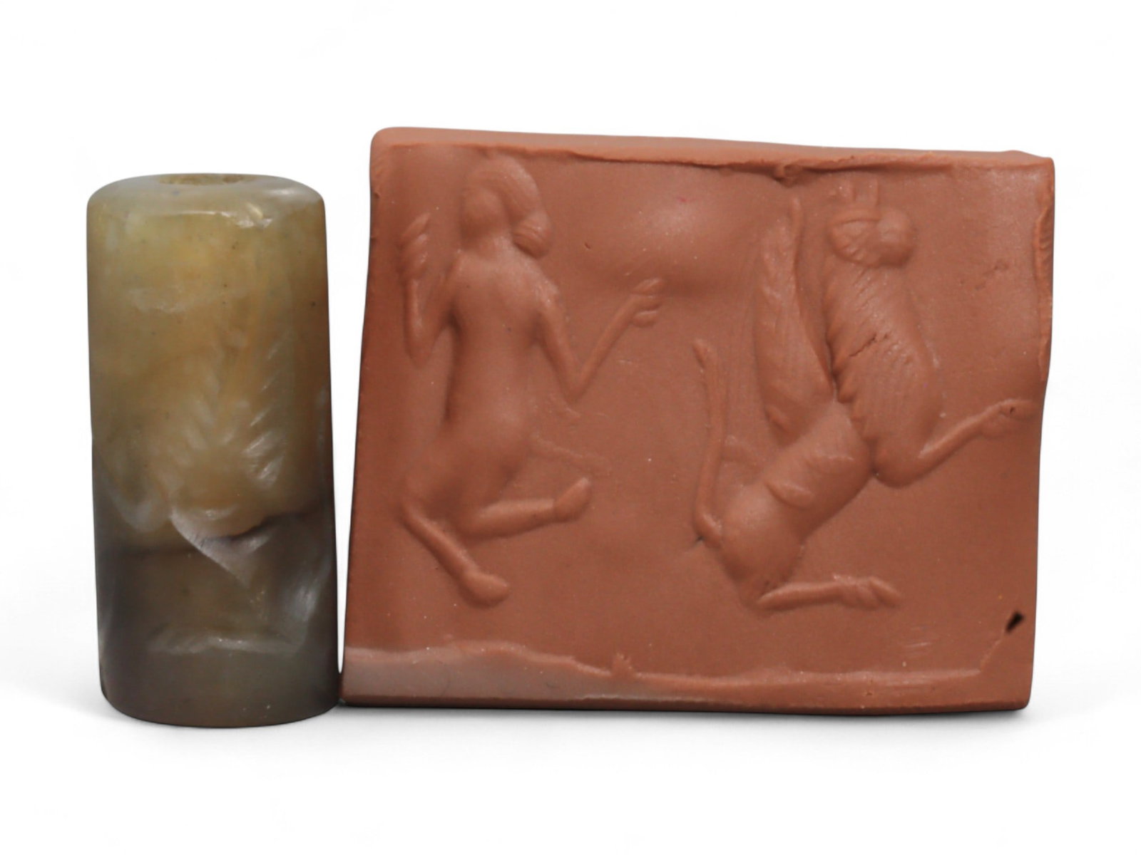 Ancient Neo-Assyrian Chalcedony Cylinder Seal Depicting Winged Deities, c. 9th-7th Century BCE,: This finely carved chalcedony cylinder seal, dating to the Neo-Assyrian Empire (c. 900-700 BCE), exemplifies the extraordinary craftsmanship and theological symbolism of Mesopotamian glyptic art durin