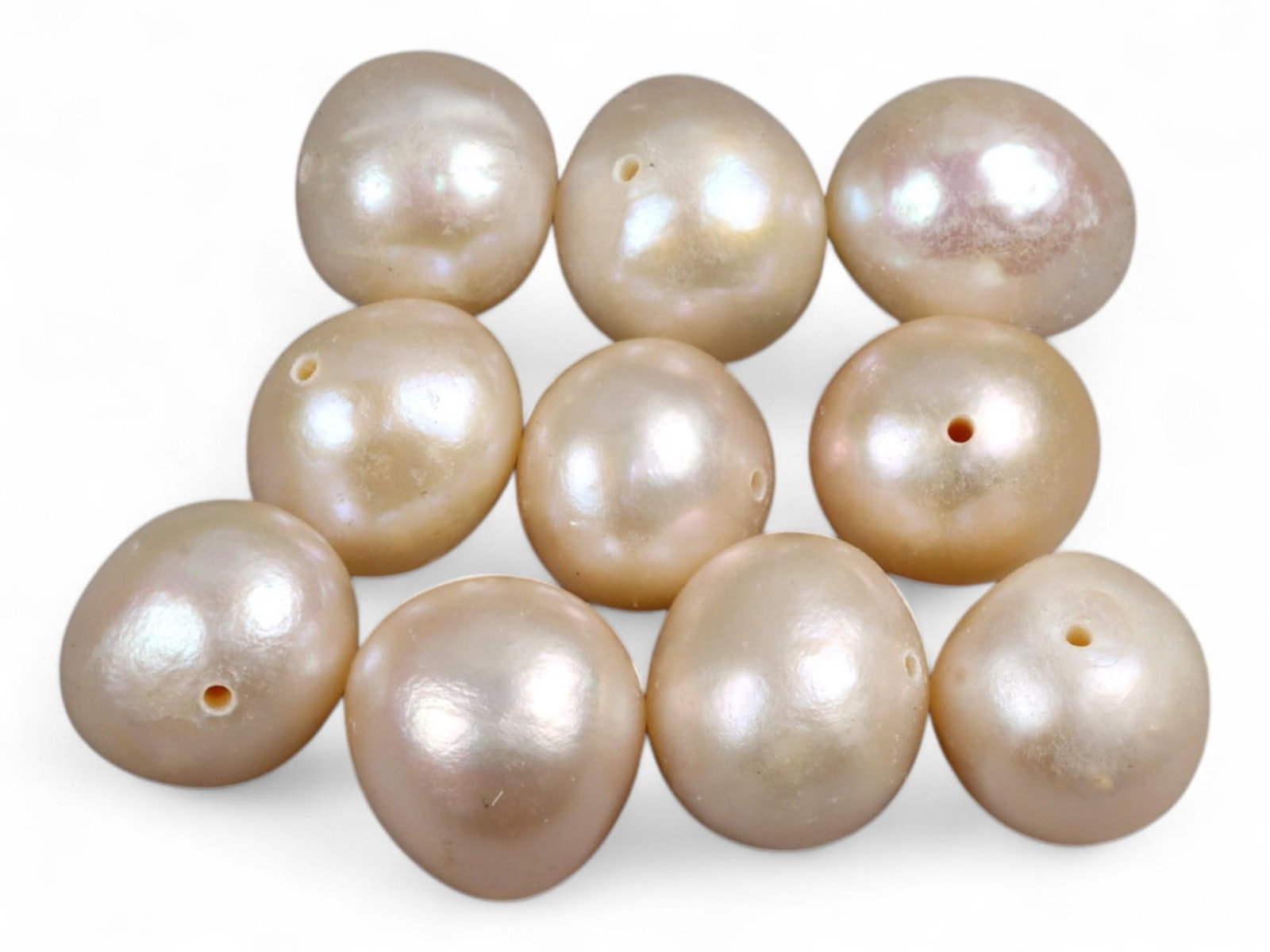 Chinese Freshwater Peach Pearl Bead Lot, 8mm 9.5g: This charming lot of Chinese freshwater pearls radiates a warm peach tone with subtle iridescent overtones of pink, gold, and cream. Each pearl measures around 8mm in diameter, their rounded baroque f