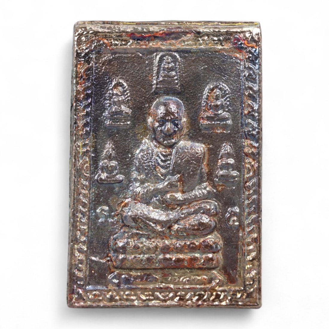 Antique Thai Luang Phor Monk Bronze Amulet Plaque, c. Mid-20th Century CE 20g: This finely detailed bronze amulet plaque features a revered Luang Phor - an honored Thai monk - seated in deep meditation, surrounded by smaller Buddha images in a sacred geometric formation. Cast du
