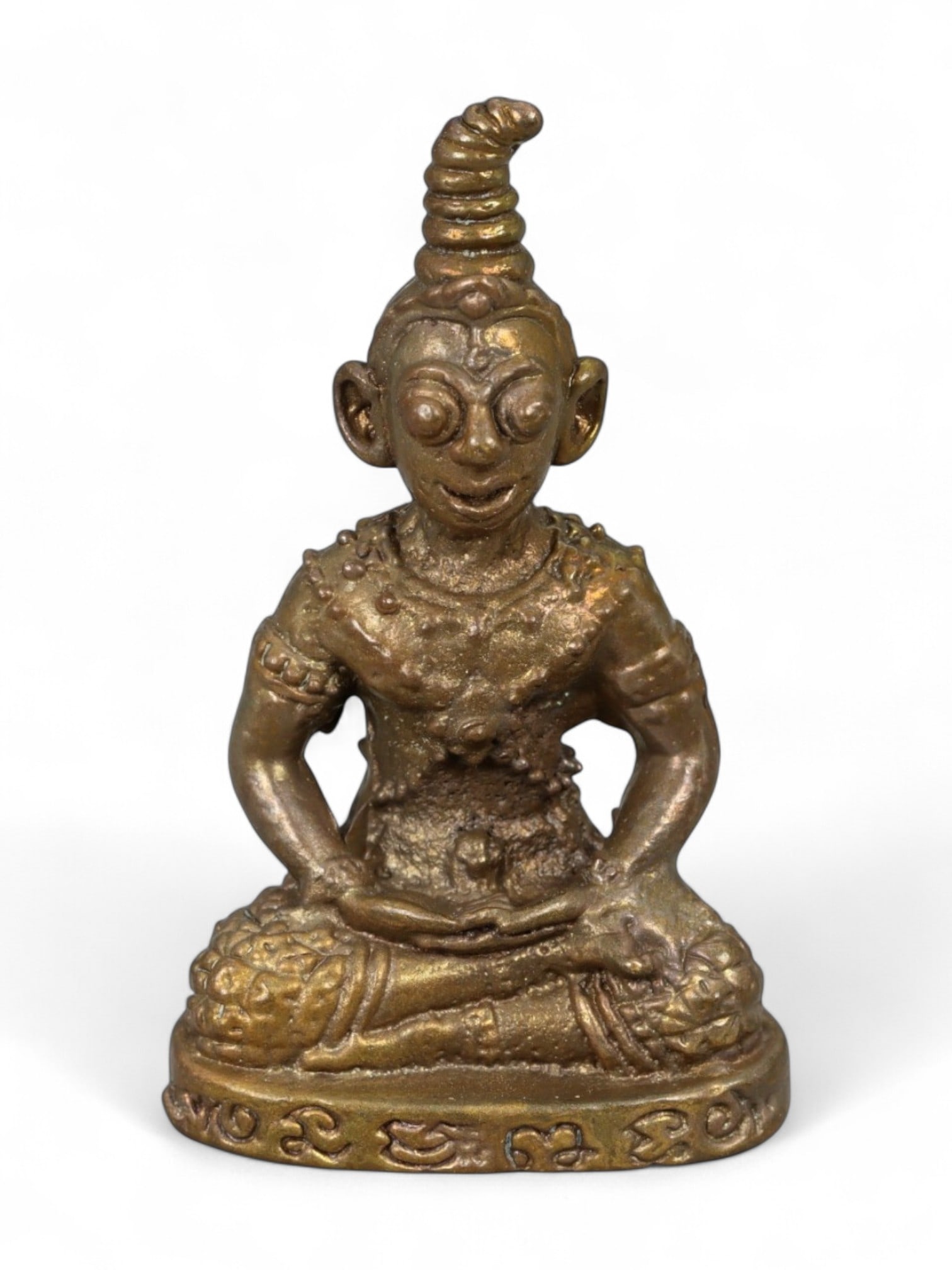Vintage Thai Rattanakosin Era Hermit Ruesi Meditation Bronze Amulet, Mid 20th Century, 14g: This unusual and charismatic bronze amulet represents a Ruesi-a hermit sage figure from Thai spiritual tradition-seated in meditative posture with distinctive exaggerated facial features and a tall co