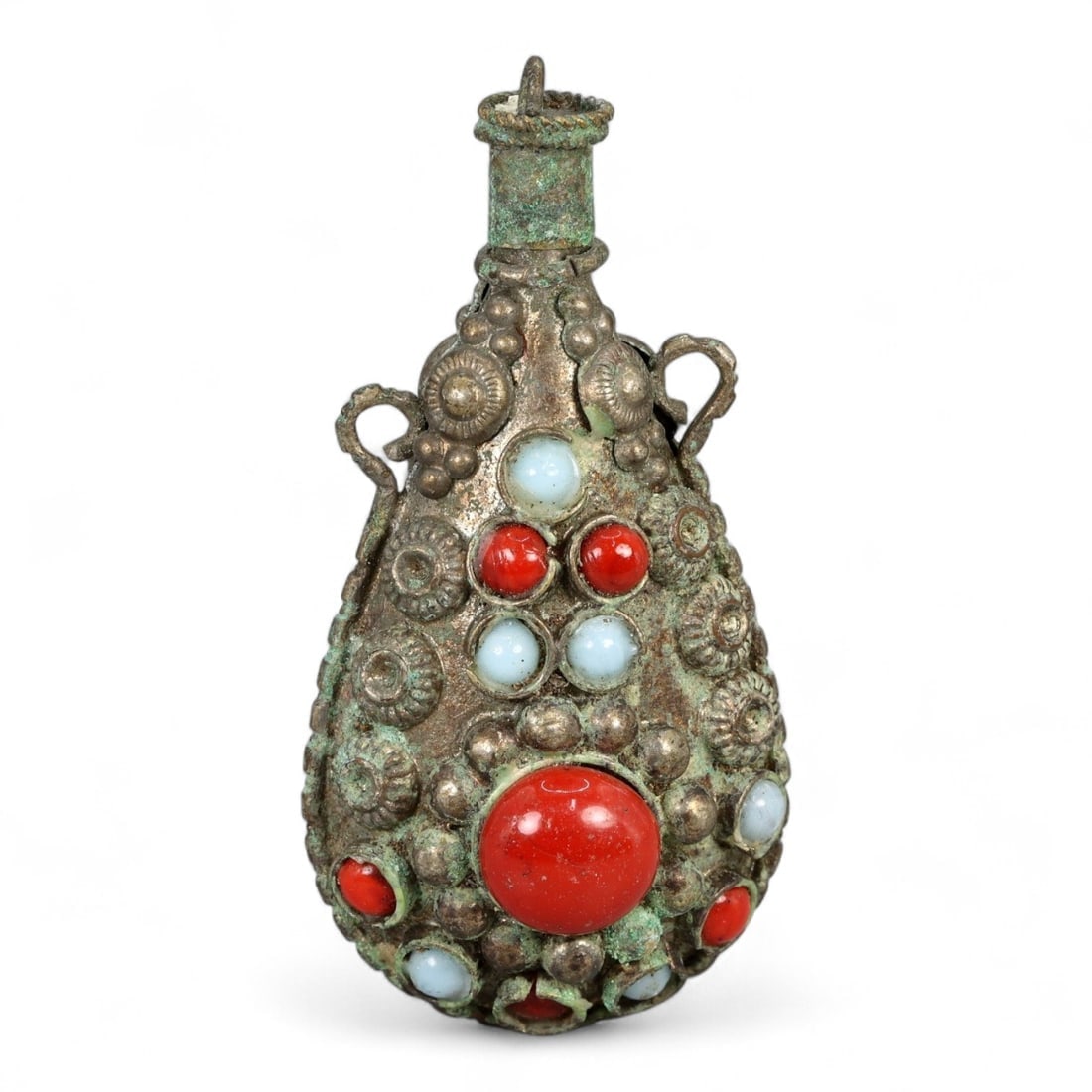 Antique Himalayan Ritual Snuff Flask Pendant with Coral and Glass Inlay, 20th Century, 23g: This ornate tear-shaped pendant, crafted in the 20th century in the Himalayan region-likely Nepal or Tibet-represents a blend of personal ornamentation and ritual utility. Designed in the form of a mi