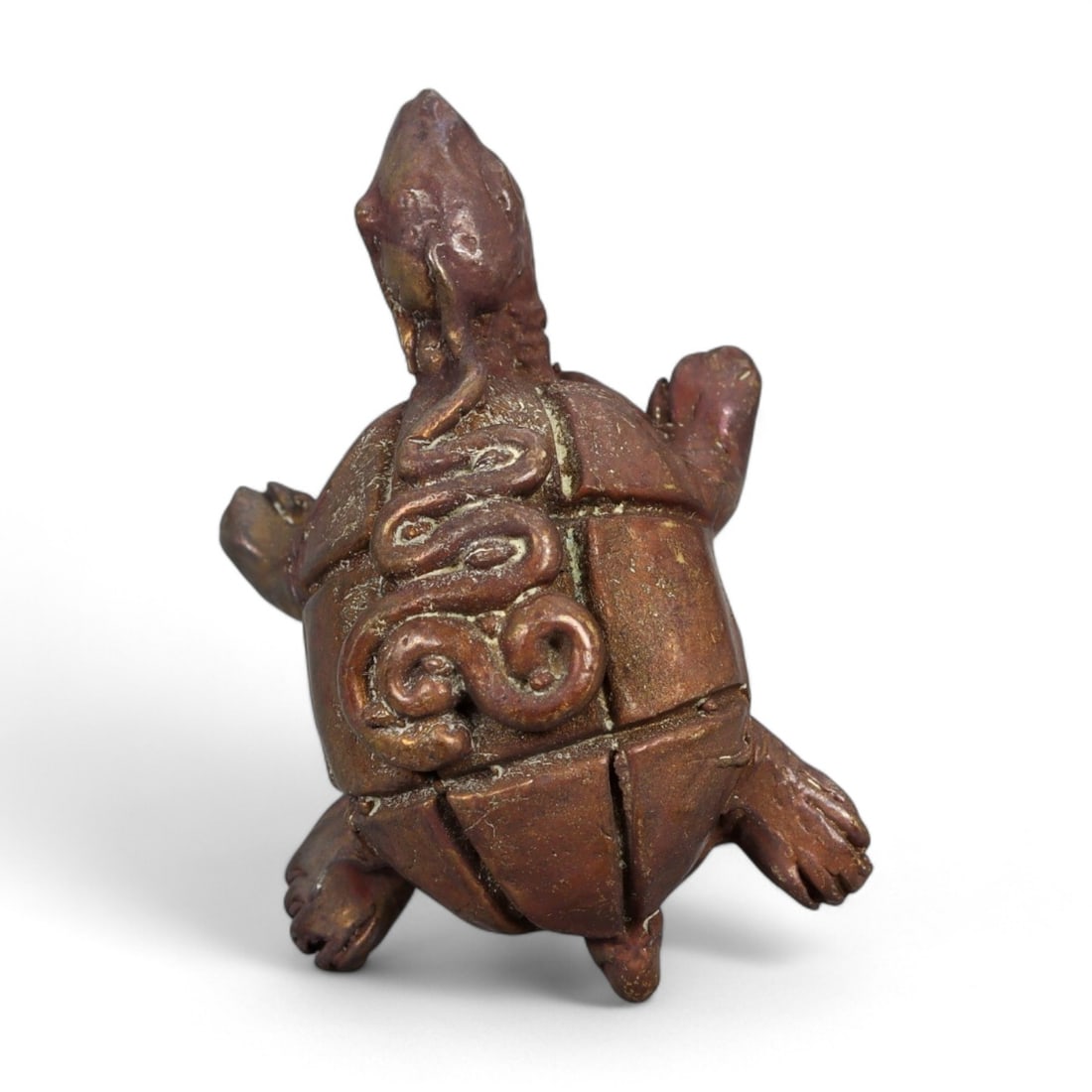 Antique Thai Turtle Amulet with Serpent Motif in Bronze, c. 19th-20th Century CE, 23g: This intriguing bronze amulet features a stylized turtle adorned with a raised serpent motif winding along its shell, a rare symbolic pairing in Thai spiritual talismanic art. Likely cast during the R