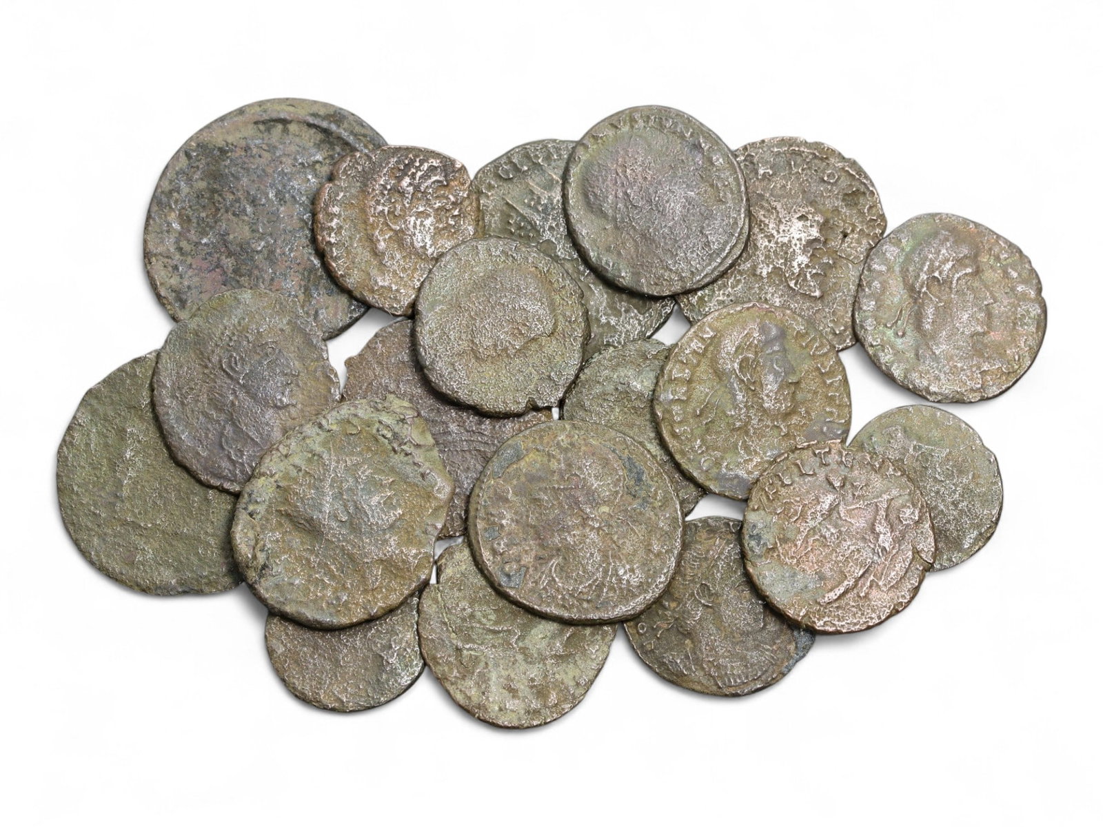 Ancient Roman Imperial Bronze Coins, Lot of 19, c. 3rd-4th Century CE, 14-24mm: This collection of nineteen bronze coins represents the monetary pulse of the Roman Empire during its later centuries, spanning the 3rd to 4th century CE. Each coin carries the portrait of emperors an