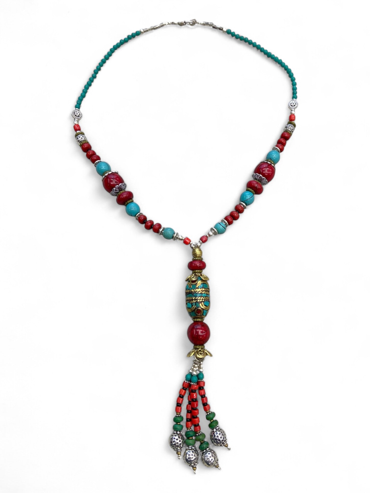Vintage Himalayan Tribal Turquoise Coral Brass Silver Tassel Necklace, 20th Century, 74g: This vintage Himalayan necklace embodies the bold vibrancy of tribal craftsmanship, with its long pendant drop design combining turquoise, coral, brass, and silver. The central inlaid turquoise and br