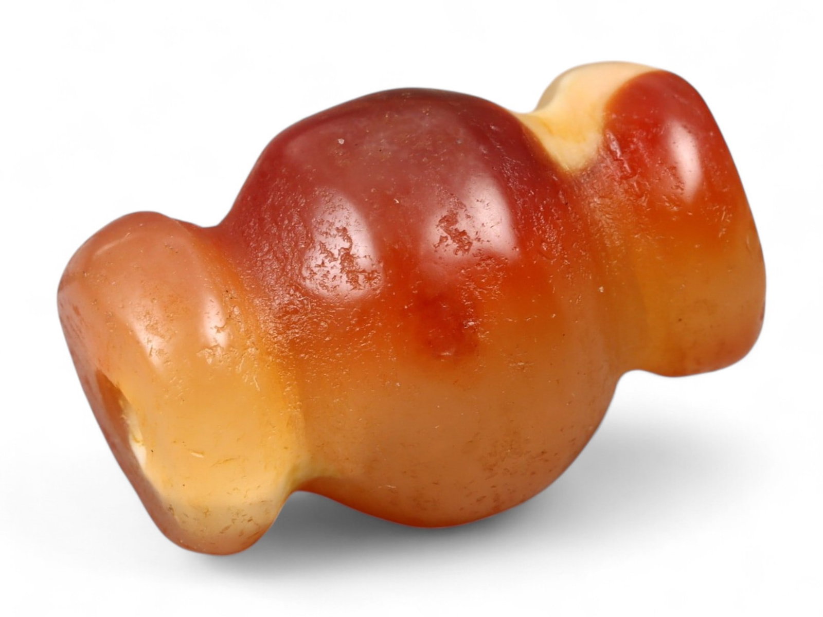 Ancient Medieval Chola Collared Carnelian Trade Bead, c. 9th-13th Century CE, 2cm, 5.2g: This finely polished carnelian bead, carved in a classic collared form, originates from the powerful Chola Dynasty of South India, a civilization that thrived between the 9th and 13th centuries CE. Th
