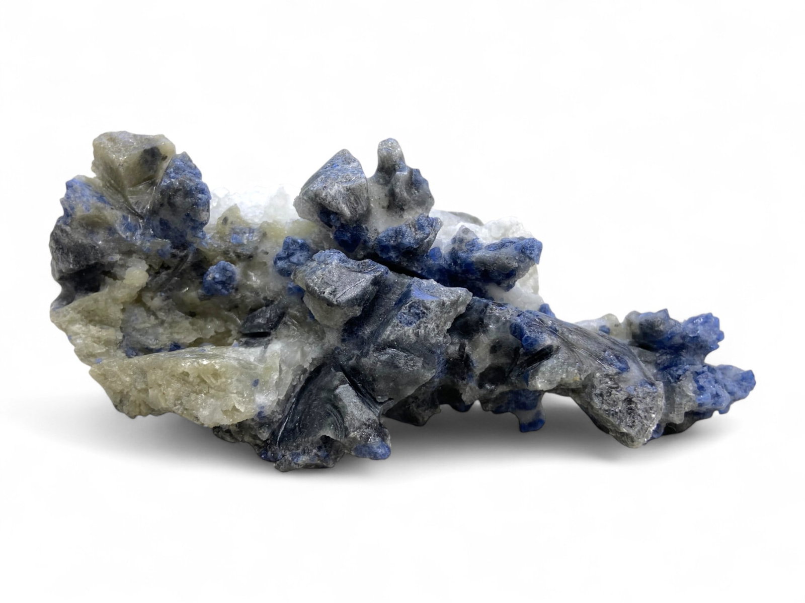 312 Grams Lazurite in Marble Matrix - Vivid Blue Crystal Veining on Sculptural Stone: This substantial 312-gram specimen features vibrant lazurite crystals embedded in a contrasting matrix of pale marble and calcite. Deep cobalt-blue veins and nodular formations spread organically acro