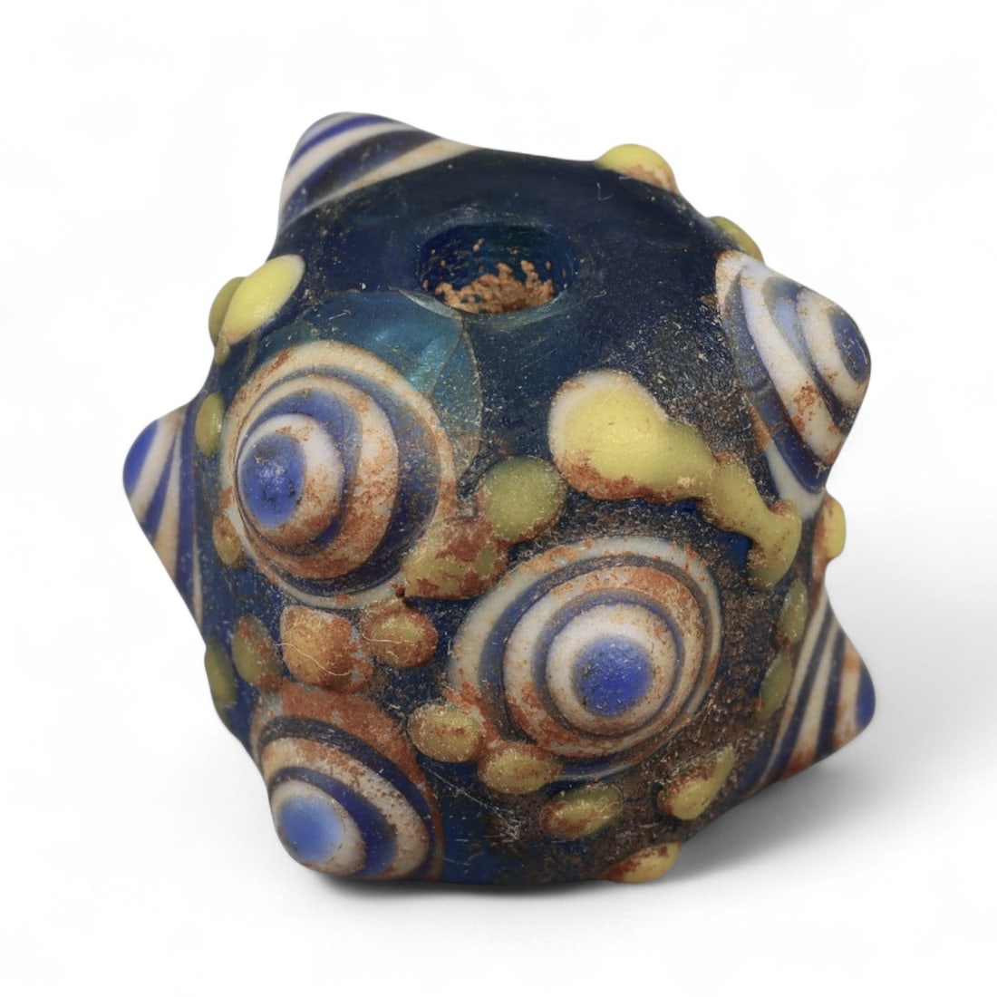 Ancient Western Asiatic Eye Mosaic Glass Bead, c. 4th-2nd Century BCE, 1.7cm: This finely crafted mosaic glass bead, originates from Western Asia and dates to the 4th-2nd century BCE. Beads of this type, often referred to as "eye beads," were highly valued across the ancient Me