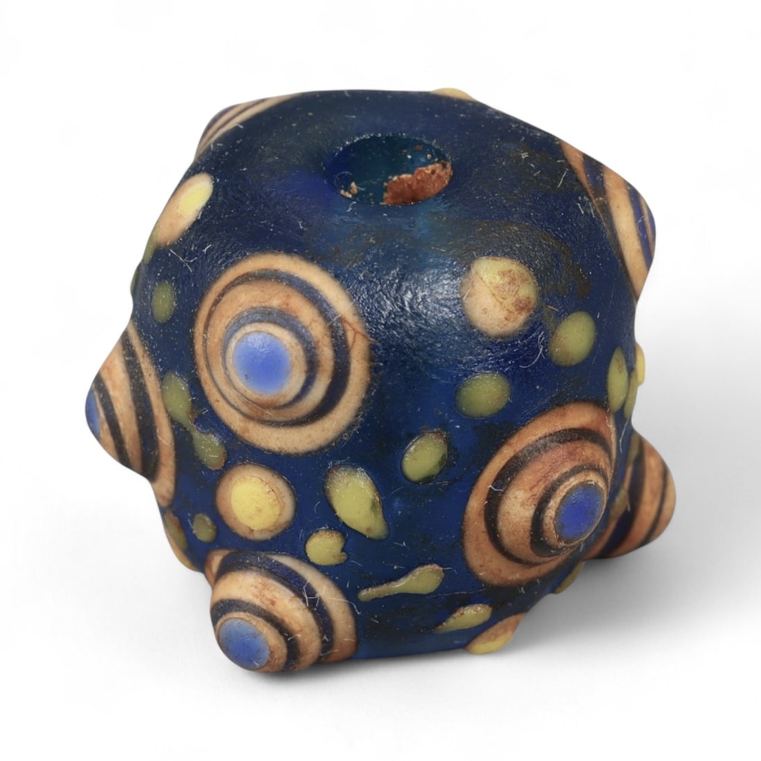 Ancient Western Asiatic Eye Mosaic Glass Bead, c. 4th-2nd Century BCE, 1.7cm: This finely crafted mosaic glass bead, originates from Western Asia and dates to the 4th-2nd century BCE. Beads of this type, often referred to as "eye beads," were highly valued across the ancient Me