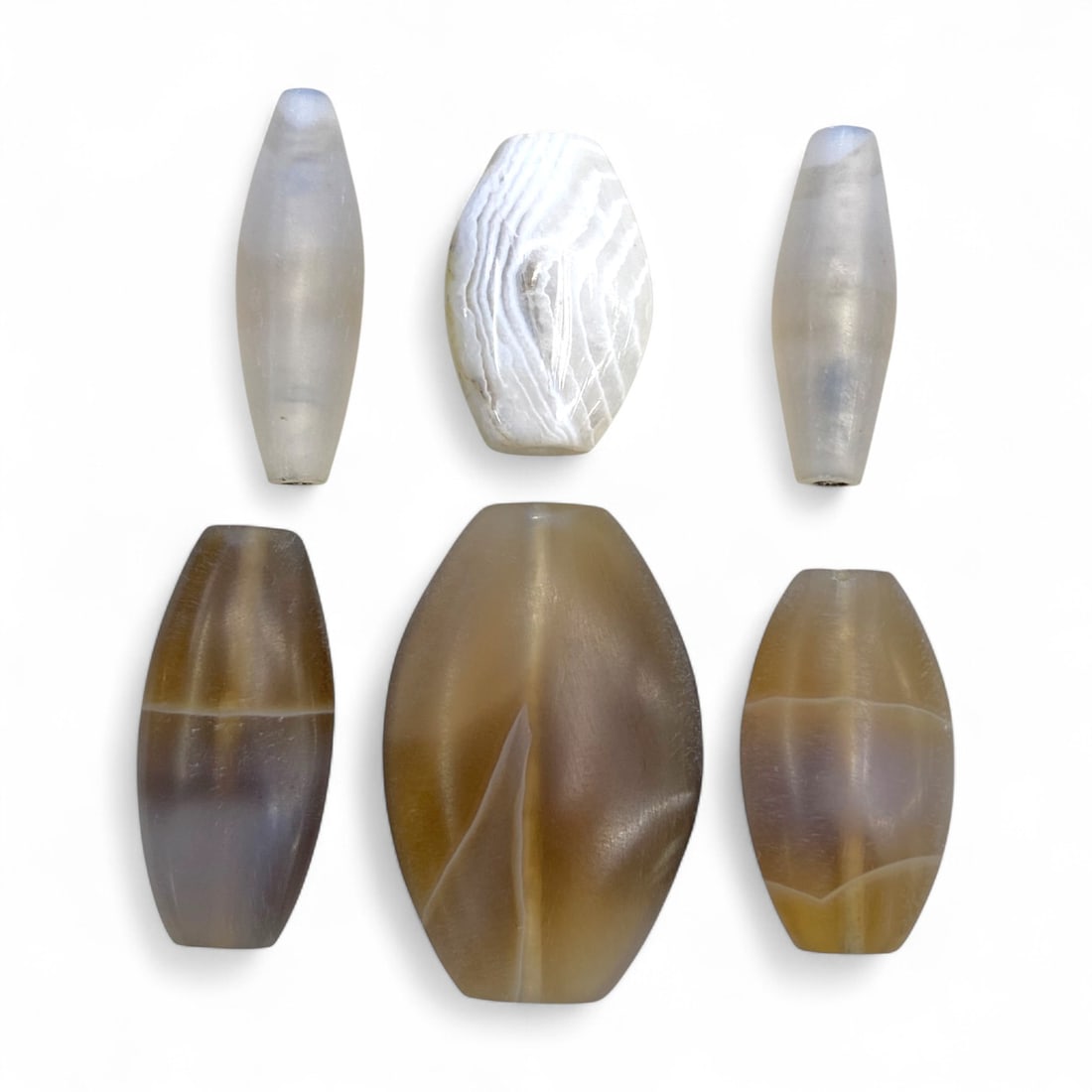 Ancient Medieval Persian Agate and Chalcedony Beads, Seljuk Period, c. 11thEUR"13th Century CE, 21g: This refined group of six beads originates from medieval Persia during the Seljuk period (c. 11thEUR"13th century CE), a time marked by flourishing artistry, trade, and luxury craftsmanship. Carved fr