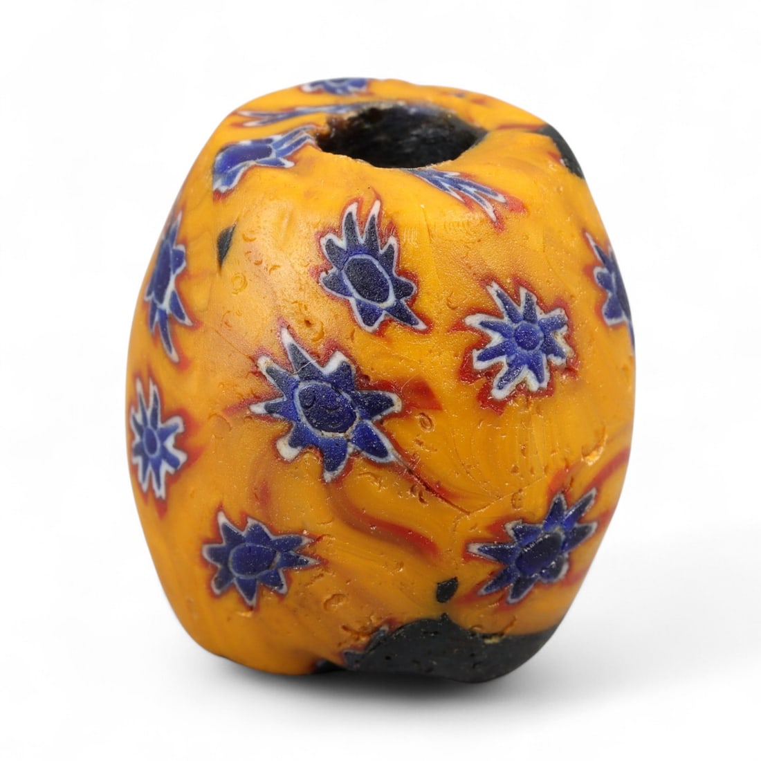 Antique Venetian Millefiori Glass Trade Bead, Orange with Blue Floral Motifs, c. 19th Century, 2.3cm: This striking Venetian millefiori bead, dating to the 19th century, features a vivid orange ground embedded with repeating blue floral starburst motifs. At 2.3 cm, it is a substantial example of Muran