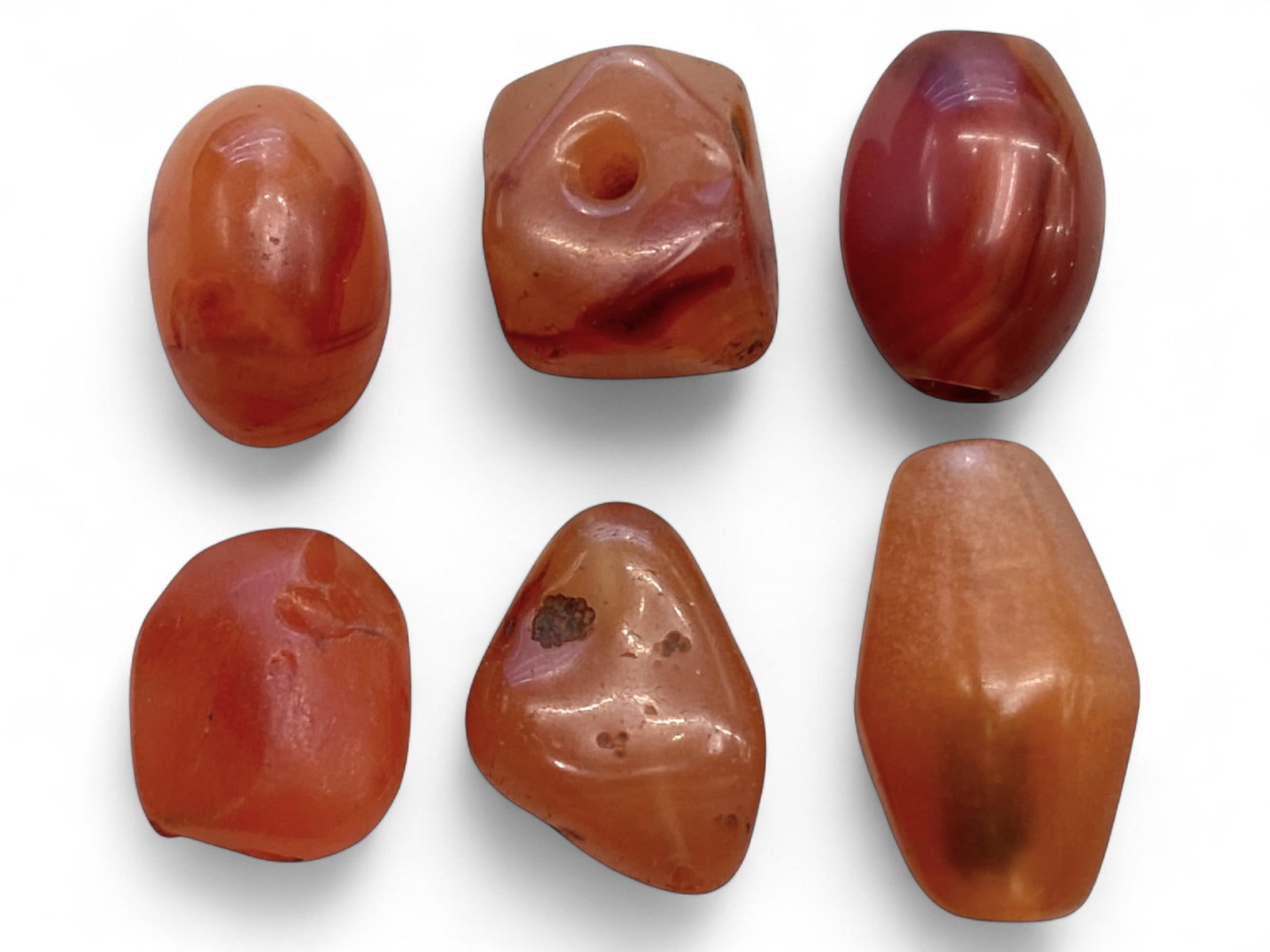 Ancient Near Eastern Carnelian Bead Set, c. 1st Millennium BCE 16g, 1.5-2cm: This group of six ancient carnelian beads, dating to the 1st millennium BCE, embodies the enduring prestige of carnelian in the spiritual and artistic life of the Near East. Together weighing 16 grams