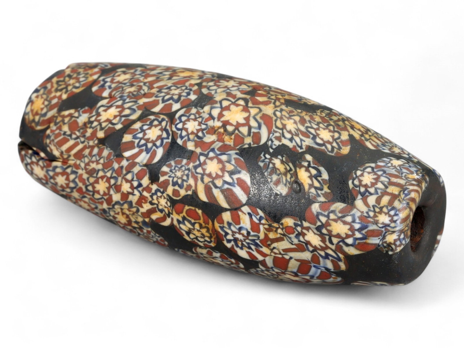 Antique Venetian Millefiori Glass Trade Bead, c. 19th Century, 7.8cm: This impressive Venetian millefiori glass bead, measuring 7.8 cm (over 3 inches), is an exceptional example of 19th-century beadmaking at its finest. Crafted in Murano, the world-renowned glassmaking 