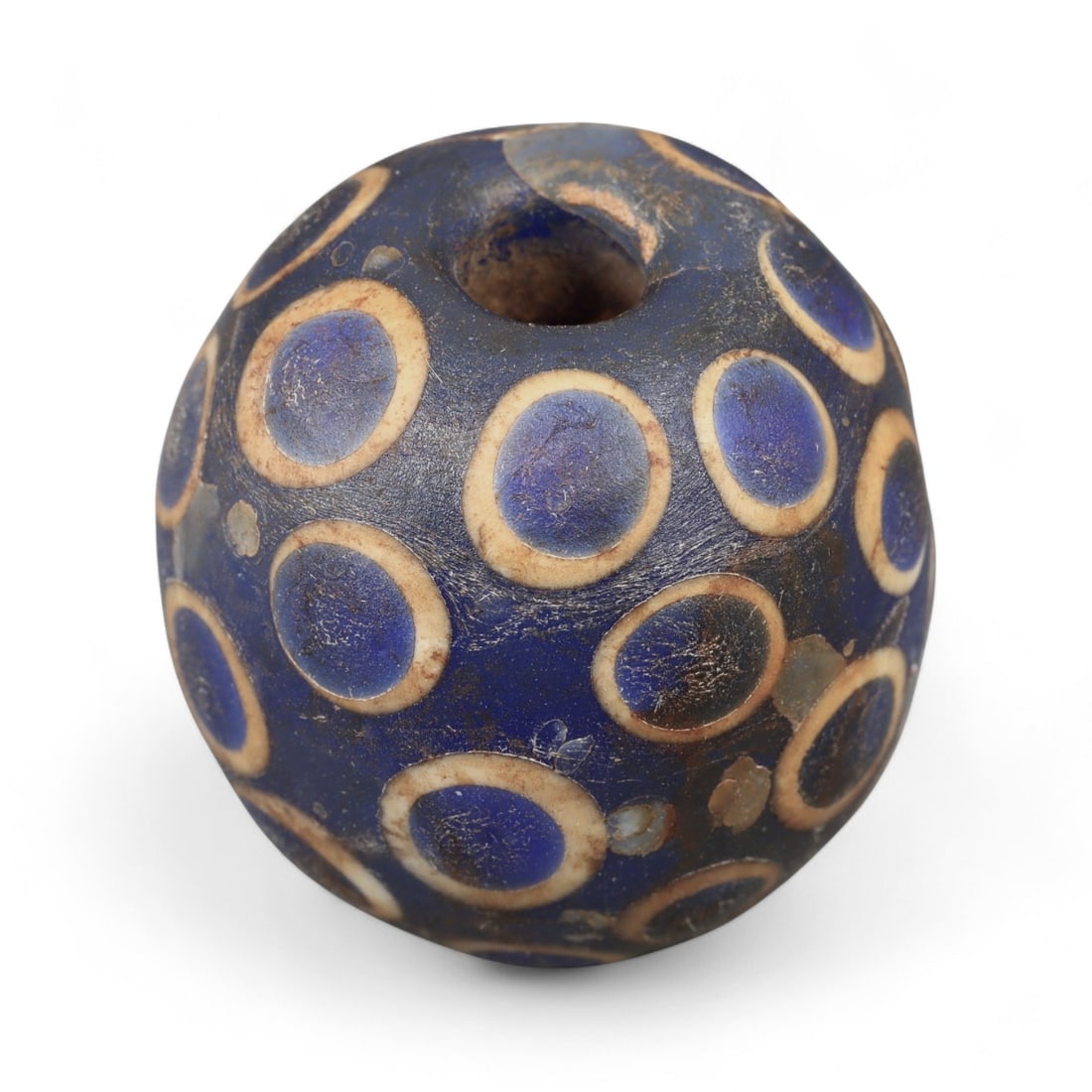 Ancient Western Asiatic Eye Mosaic Glass Bead, c. 4th-2nd Century BCE, 2.7cm: This remarkable mosaic glass bead, originates from Western Asia and dates to the 4th-2nd century BCE, a period when glassmaking reached new heights of technical mastery. Often referred to as "eye bead