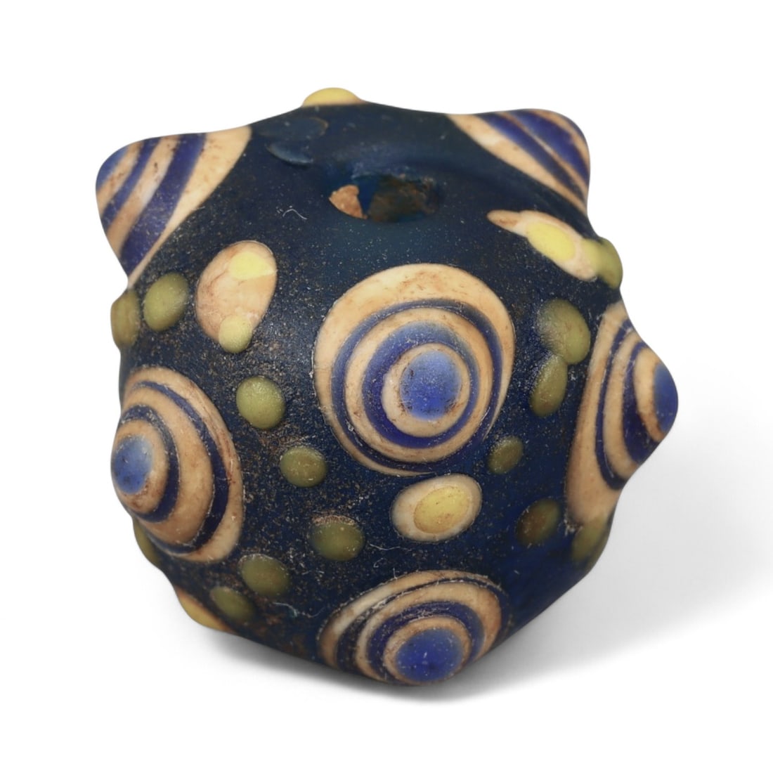 Ancient Western Asiatic Eye Mosaic Glass Bead, c. 4th-2nd Century BCE, 2.1cm: This finely crafted mosaic glass bead, originates from Western Asia and dates to the 4th-2nd century BCE. Beads of this type, often referred to as "eye beads," were highly valued across the ancient Me