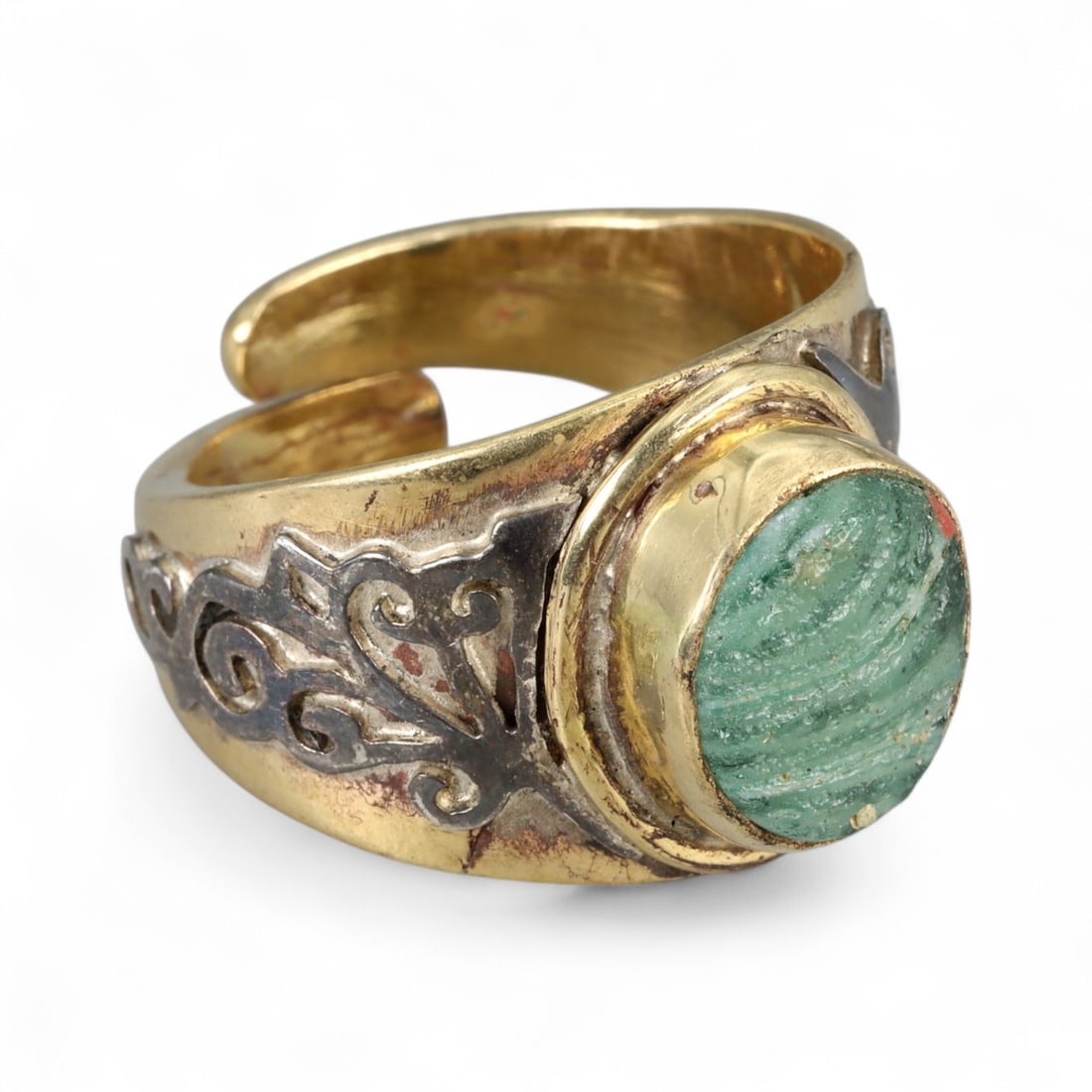 Vintage Tibetan Green Aventurine Adjustable Silver Gilt Ring, 20th Century: This vintage Tibetan ring showcases the spiritual elegance of Himalayan craftsmanship, created in silver gilt for both durability and luminous appeal. At its center rests a polished green aventurine c