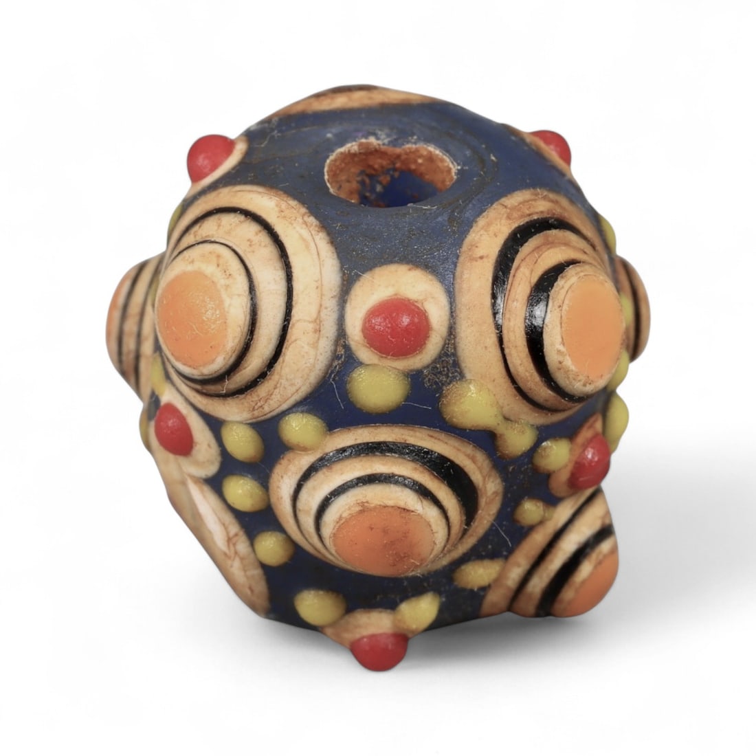 Ancient Western Asiatic Polychrome Blue-Orange Node-Eye Glass Bead, c. 4th-2nd Century BCE 2cm: This vibrant glass bead originates from Western Asia and dates to the late Achaemenid to early Hellenistic period, c. 4th-2nd century BCE. Such beads were prized along the vast trade routes that conne