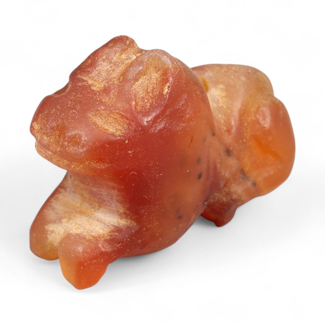 Ancient Coptic Egyptian Carnelian Feline Amulet, c. 5th-7th Century CE, 1.9cm: This finely carved amulet, depicts a feline, sculpted in warm reddish-brown carnelian with lighter mineral veining. Created during the Coptic Egyptian period, c. 5th-7th century CE, it reflects the co