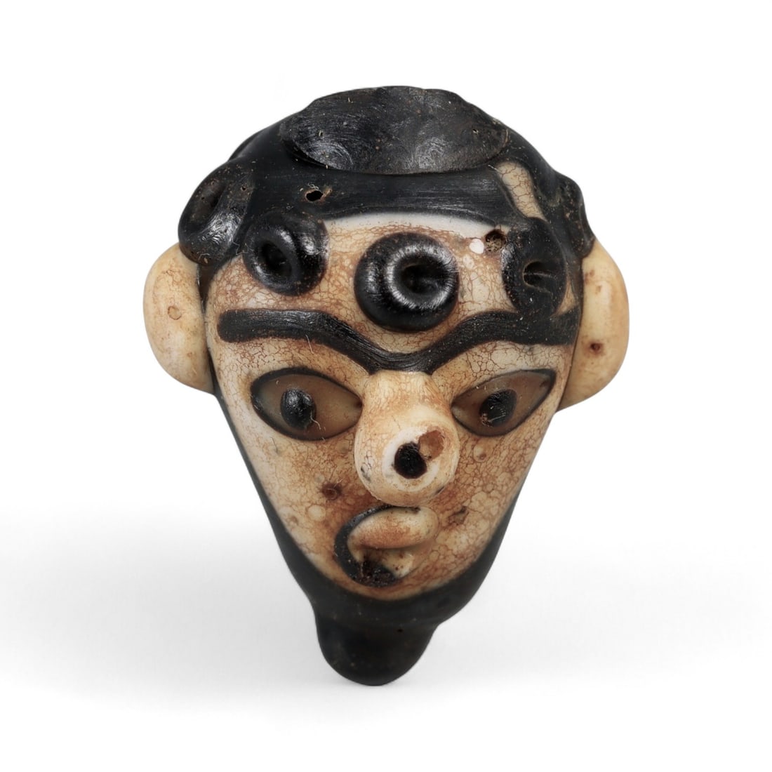 Ancient Phoenician Polychrome Glass Face Bead, c. 6th-3rd Century BCE, 3cm: This striking ancient glass face bead, measuring 3 cm, originates from the Phoenician world and dates to the 6th-3rd centuries BCE. Phoenician craftsmen were among the earliest and most skilled glassw