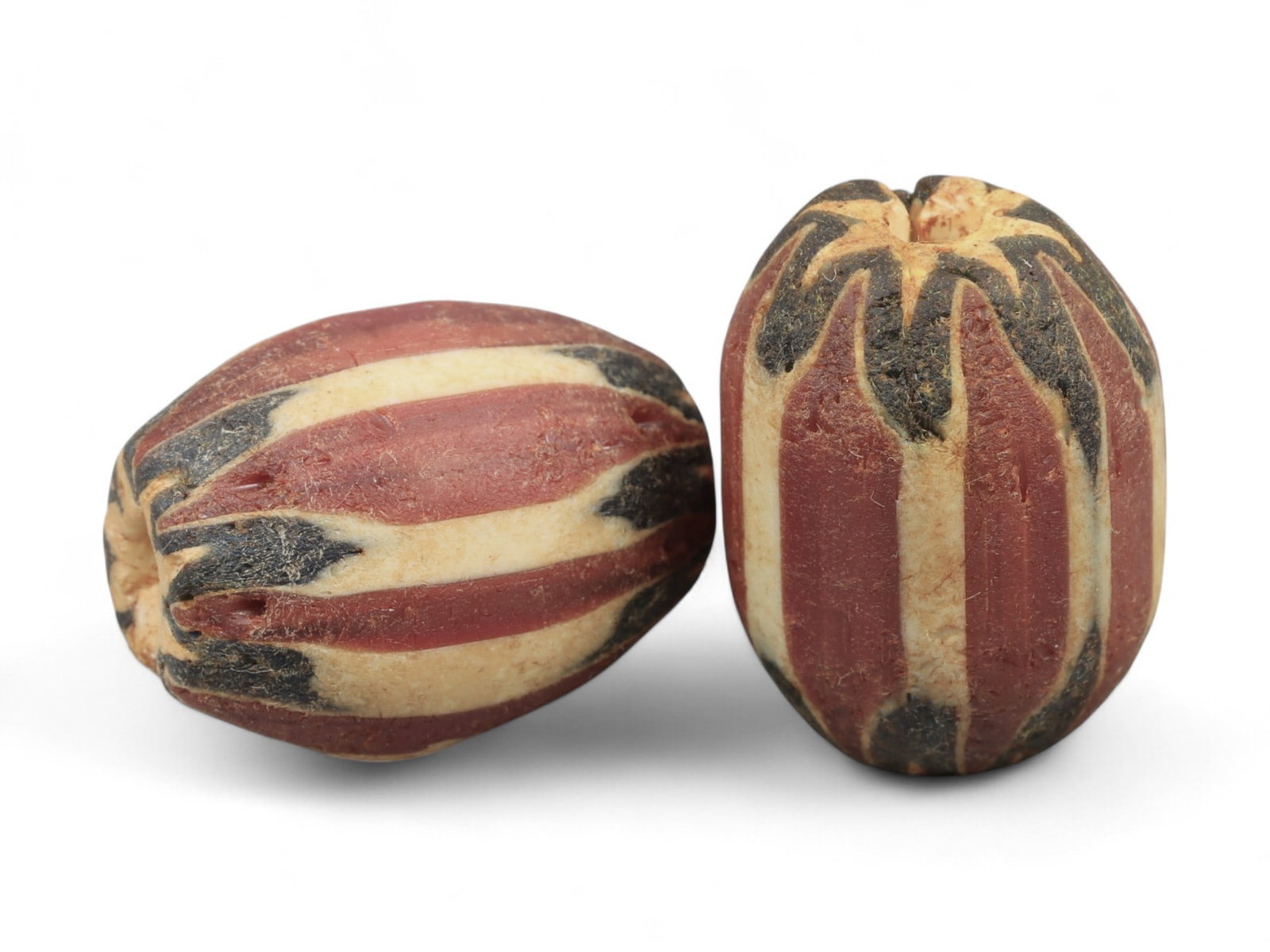 Antique Venetian Chevron Trade Glass Beads, c. 18th-19th Century, 2.1cm: These striking antique glass beads originate from Venice, renowned during the 18th and 19th centuries for its unparalleled glassmaking traditions centered in Murano. Known as chevron beads, they were 