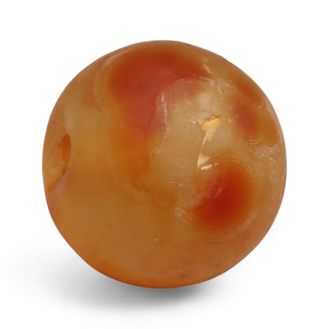 Antique Tibetan Carnelian Mala Prayer Bead, c. 18th-19th Century, 1.7cm: This antique carnelian mala bead comes from the highlands of Tibet, where prayer beads have served as essential spiritual tools for centuries. It is carved from warm, translucent carnelian, a gemstone