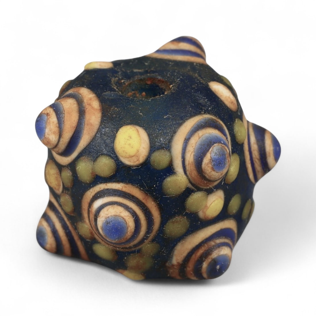 Ancient Western Asiatic Eye Mosaic Glass Bead, c. 4th-2nd Century BCE, 1.8cm: This finely crafted mosaic glass bead, originates from Western Asia and dates to the 4th-2nd century BCE. Beads of this type, often referred to as "eye beads," were highly valued across the ancient Me