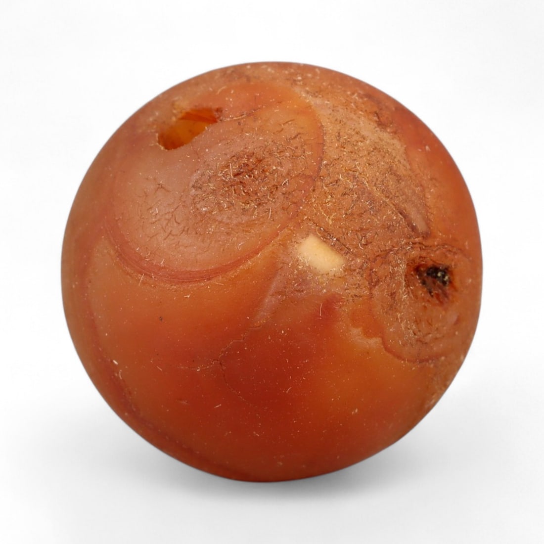 Antique Tibetan Carnelian Mala Prayer Bead, c. 18th-19th Century, 1.7cm: This antique carnelian mala bead originates from the Himalayan cultural sphere, most likely 18th-19th century Tibet, a period when devotional craftsmanship flourished under the influence of both Buddh