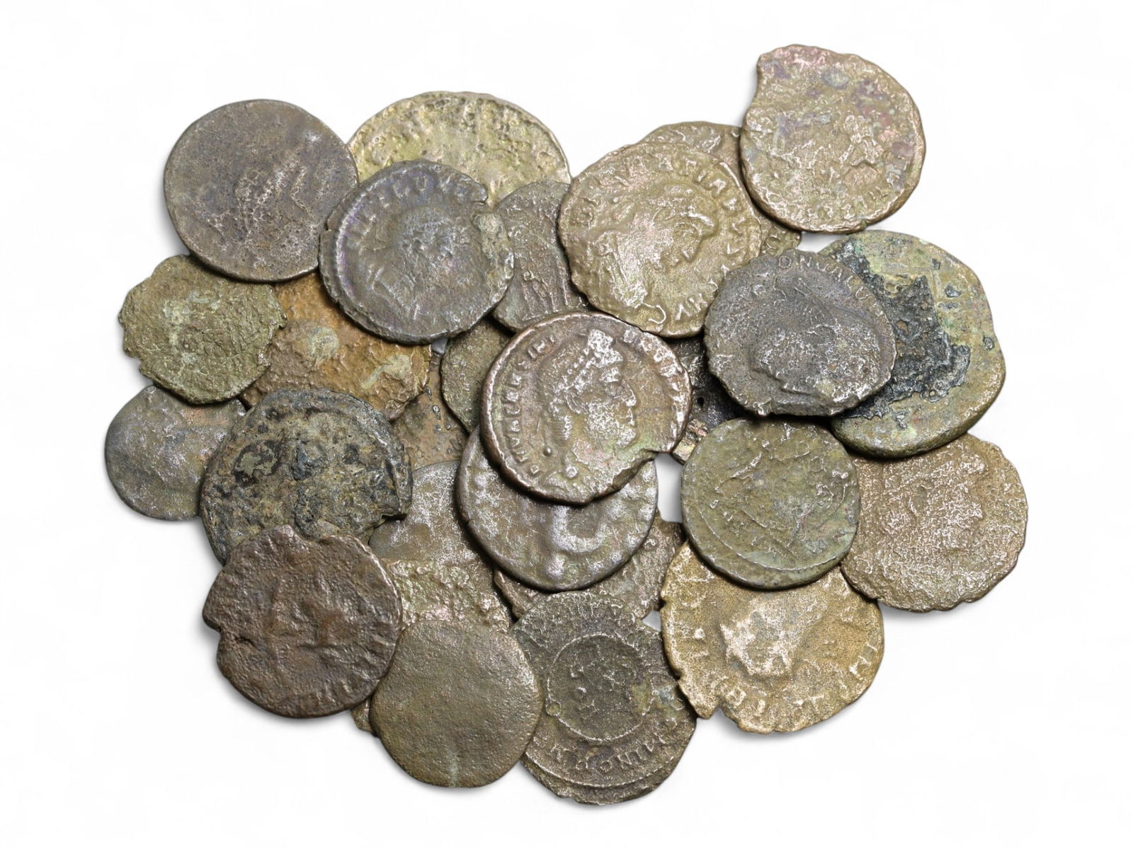 Ancient Roman Bronze Coins Lot, AE3 and AE4, c. 3rd-5th Century CE, 25 Coins: This lot of 25 bronze coins represents the currency of the late Roman Empire, spanning the 3rd to 5th centuries CE. These pieces, known as AE3 and AE4 denominations, were the small change of the Roman