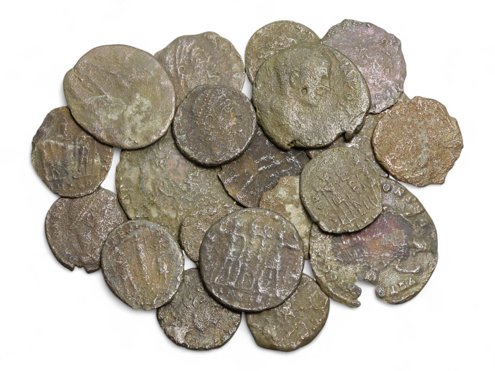 Ancient Roman Bronze Coins Lot, AE3 and AE4, c. 3rd-5th Century CE, 25 Coins: This lot of 25 bronze coins represents the currency of the late Roman Empire, spanning the 3rd to 5th centuries CE. These pieces, known as AE3 and AE4 denominations, were the small change of the Roman