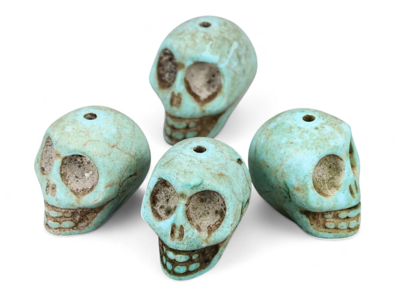 Vintage Tibetan Turquoise Skull Beads, Set of Four, c. Mid-20th Century, 2cm: This striking set of four turquoise-carved skull beads, originates from Tibet and dates to the mid-20th century. Finely shaped and perforated for stringing, each bead represents a human skull, a motif