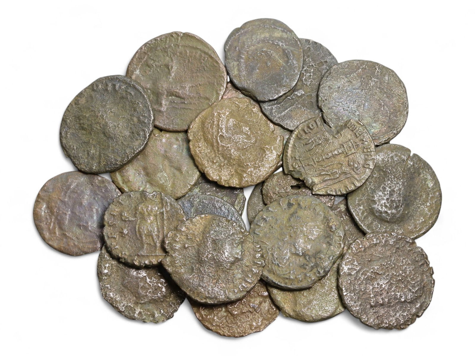 Ancient Roman Bronze Coins Lot, AE3 and AE4, c. 3rd-5th Century CE, 25 Coins: This lot of 25 bronze coins represents the currency of the late Roman Empire, spanning the 3rd to 5th centuries CE. These pieces, known as AE3 and AE4 denominations, were the small change of the Roman