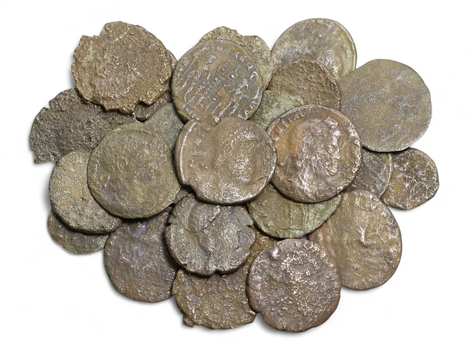 Ancient Roman Bronze Coins Lot, AE3 and AE4, c. 3rd-5th Century CE, 25 Coins: This lot of 25 bronze coins represents the currency of the late Roman Empire, spanning the 3rd to 5th centuries CE. These pieces, known as AE3 and AE4 denominations, were the small change of the Roman